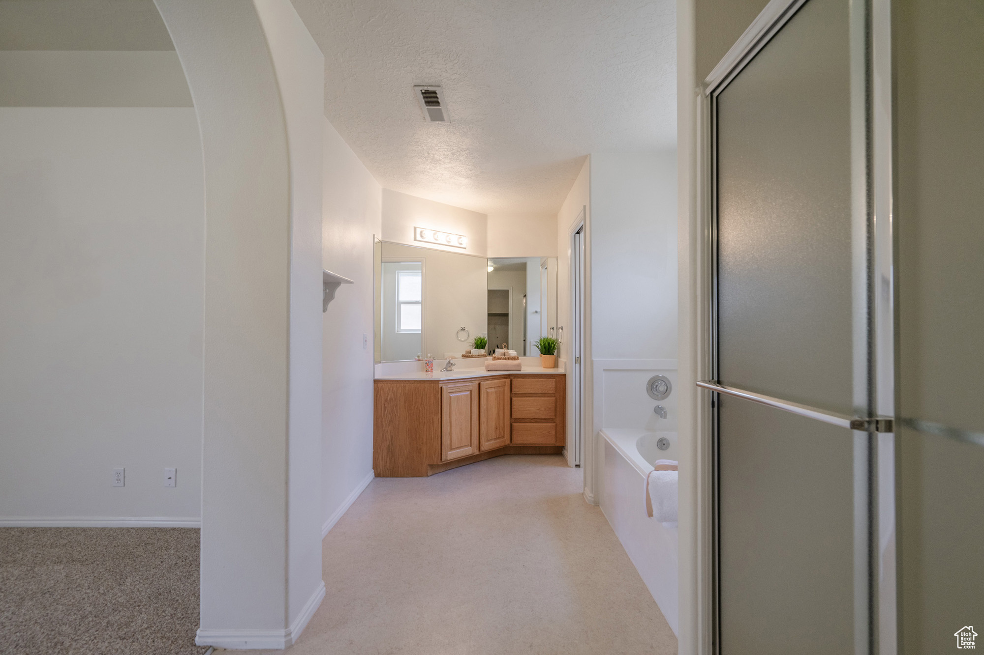 Primary Bathroom featuring  walk in shower, vanity and jetted tub