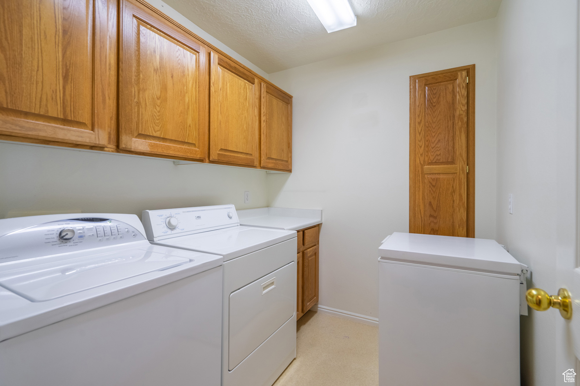 Clothes washing area with washer and clothes dryer, and cabinets