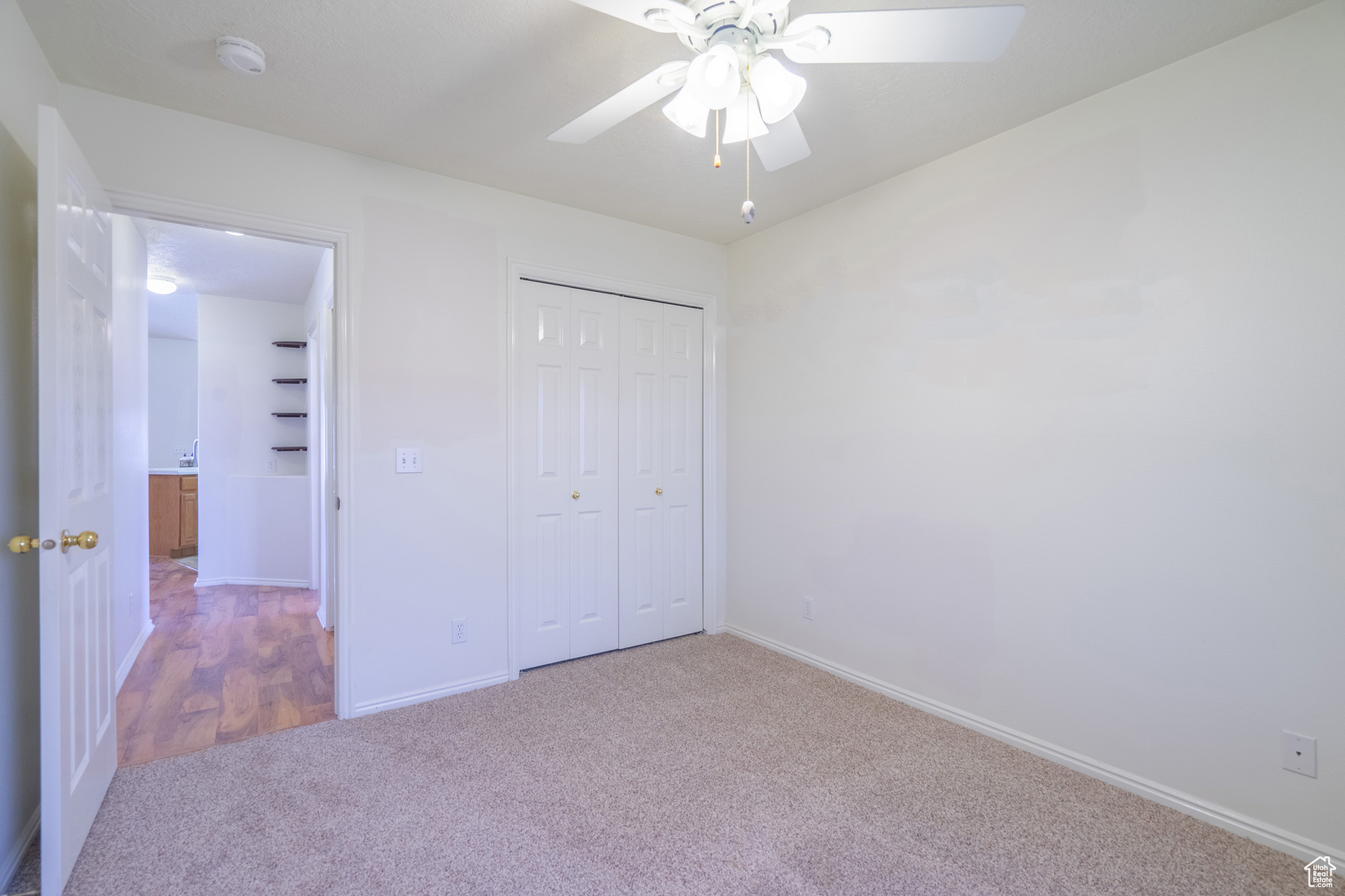 Guest bedroom with carpet and ceiling fan