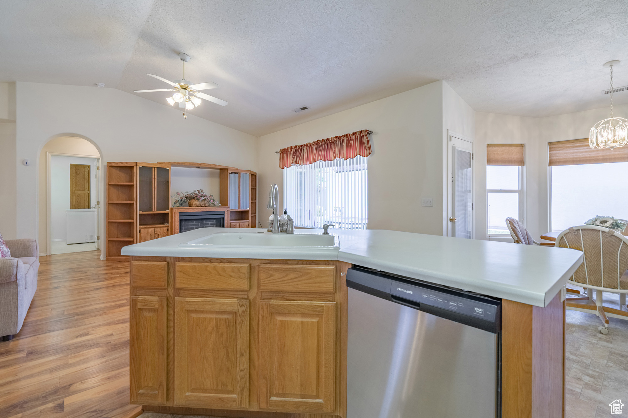 Kitchen featuring center island, sink, and white appliances