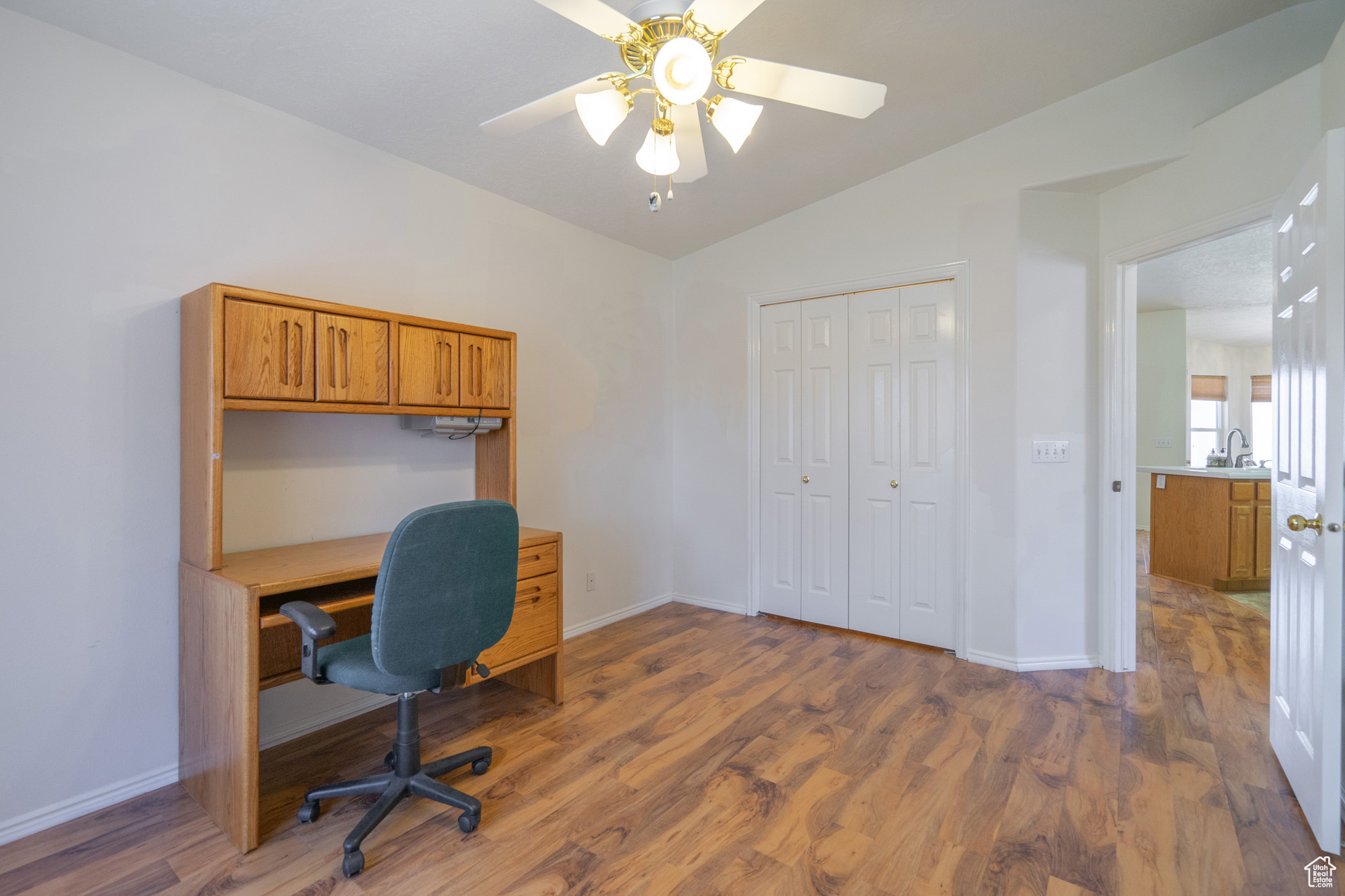 Guest Bedroom/Office area featuring hardwood / wood-style flooring, lofted ceiling, and ceiling fan