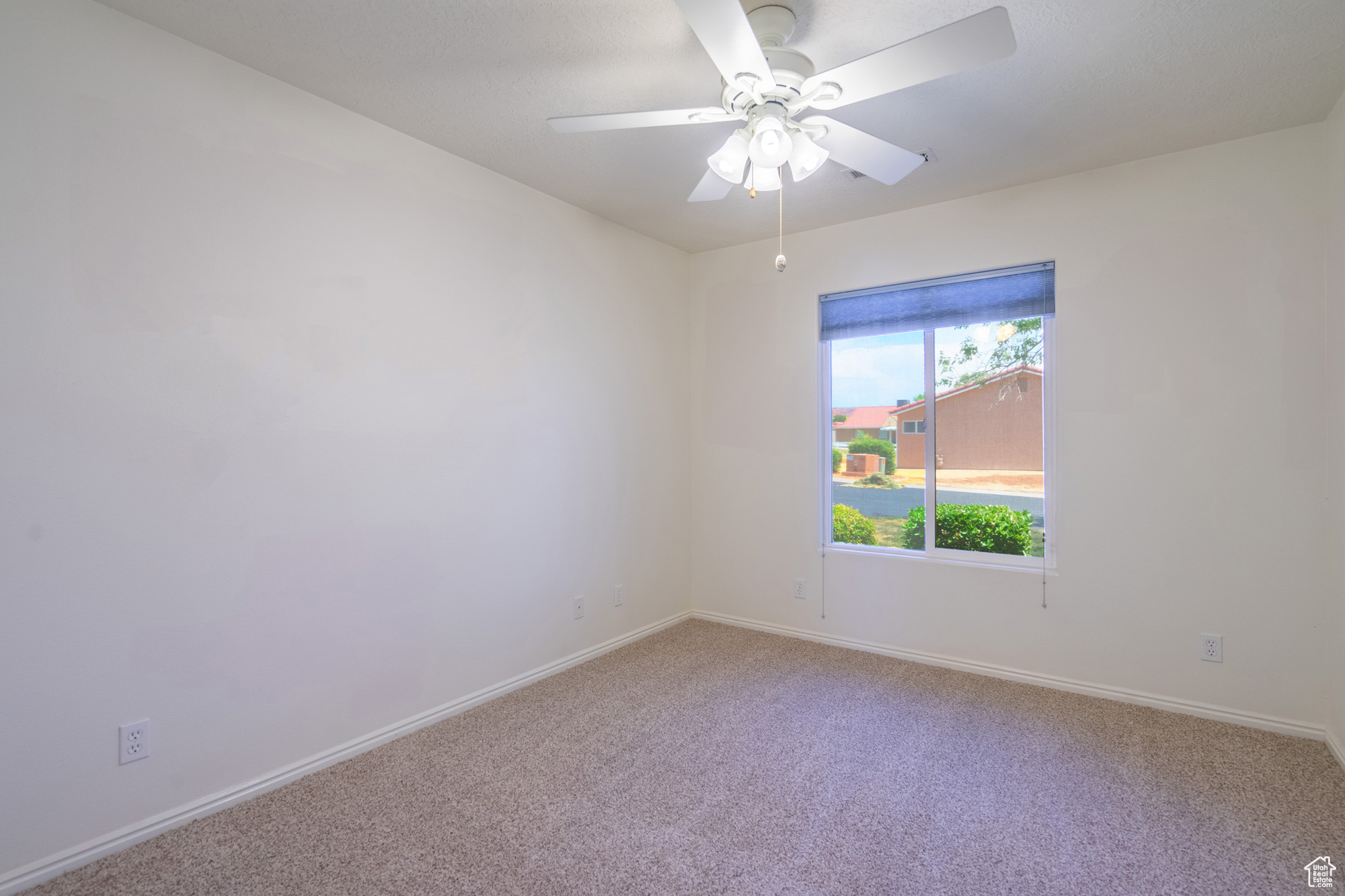 Guest bedroom with carpet and ceiling fan