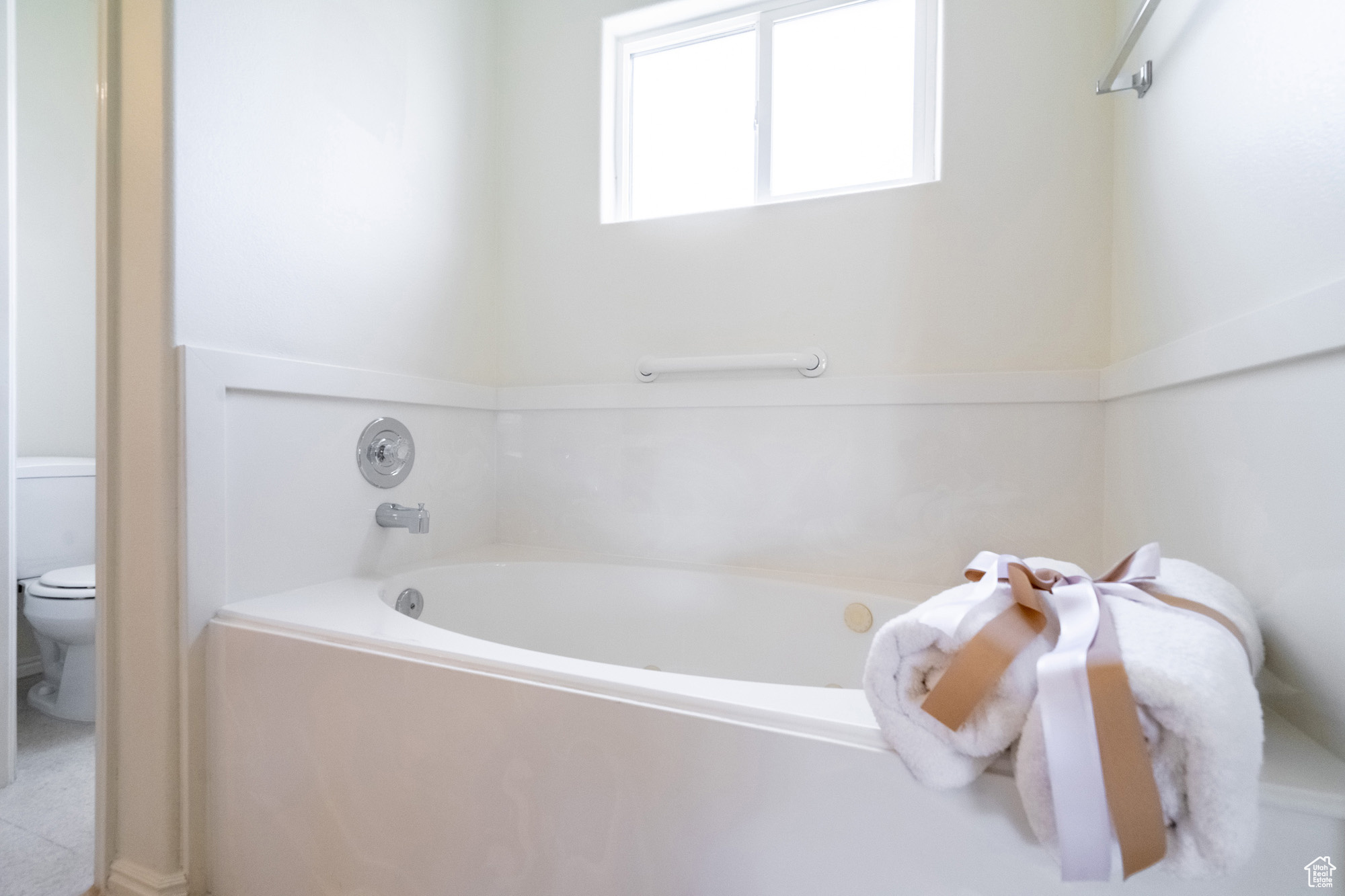 Primary Bathroom featuring toilet and a bathing tub