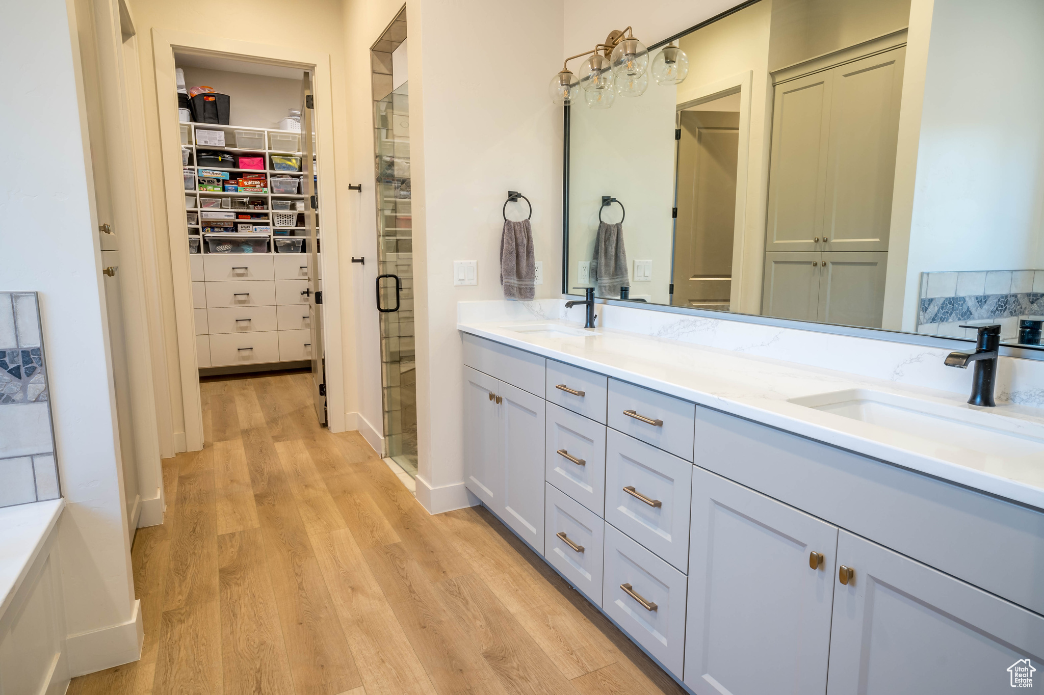 Master Bathroom with double sink vanity and wood-type flooring