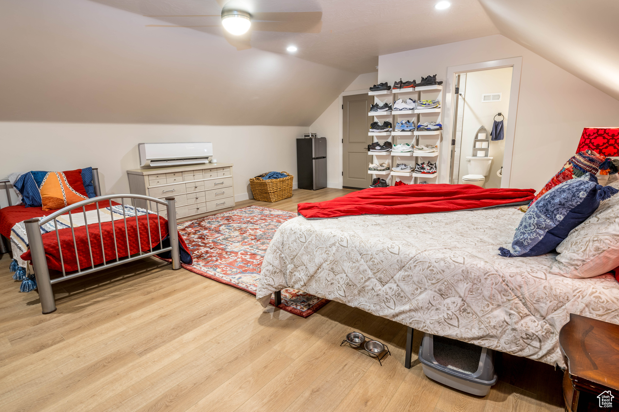 Loft/Bedroom 4 with ceiling fan, hardwood / wood-style floors,  ensuite bath, and lofted ceiling