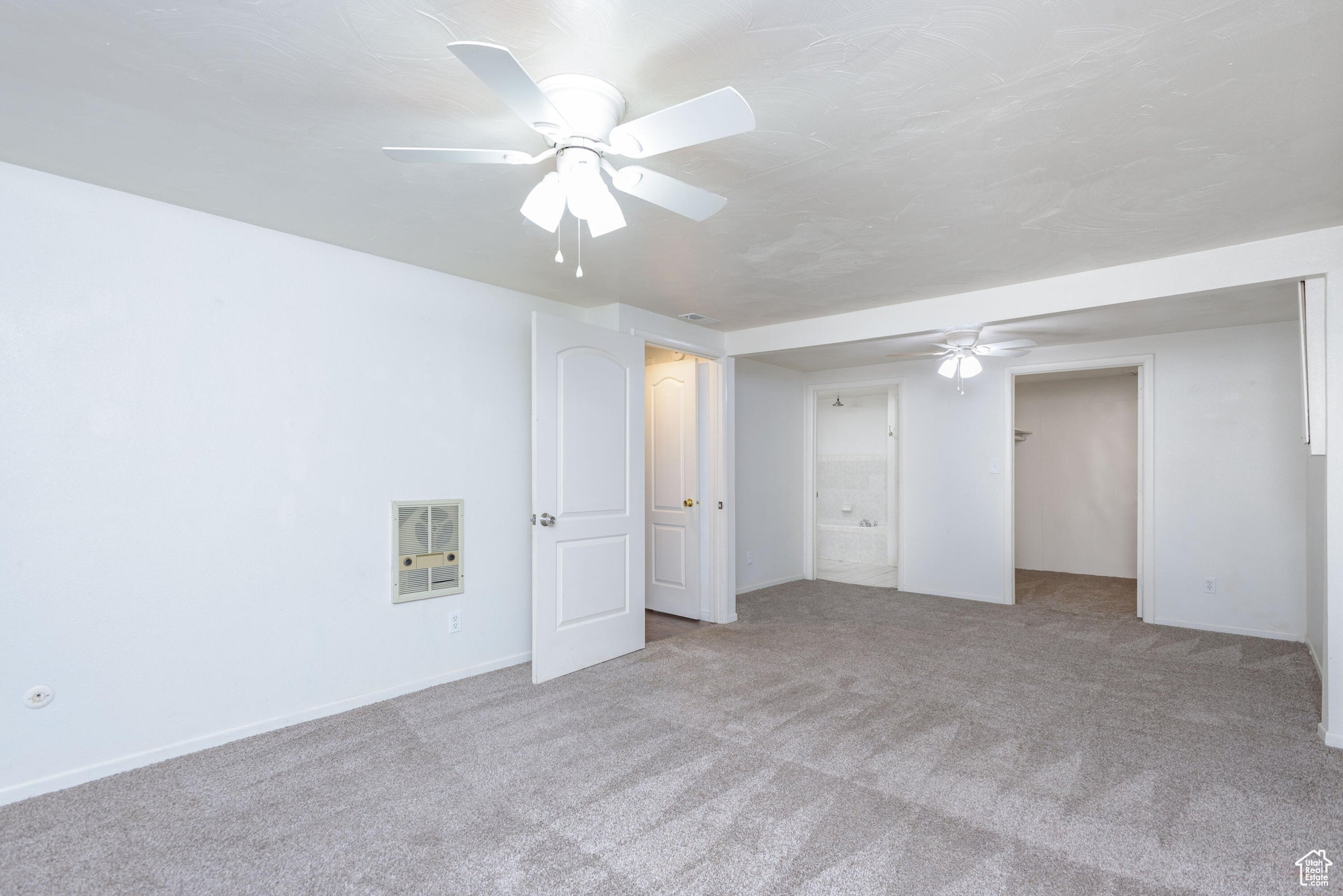 Unfurnished bedroom with light carpet, a closet, and ceiling fan