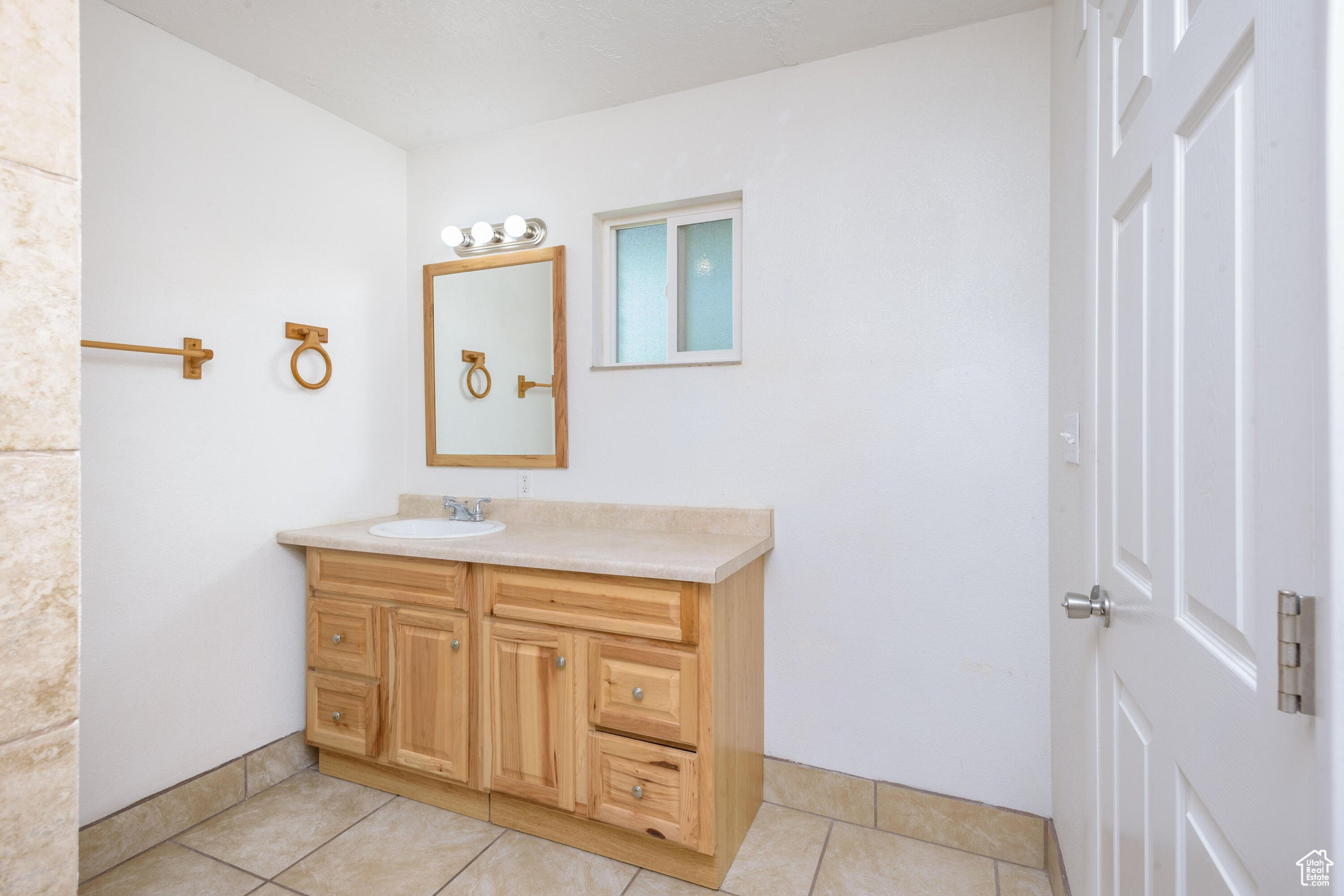 Bathroom with tile patterned flooring and vanity