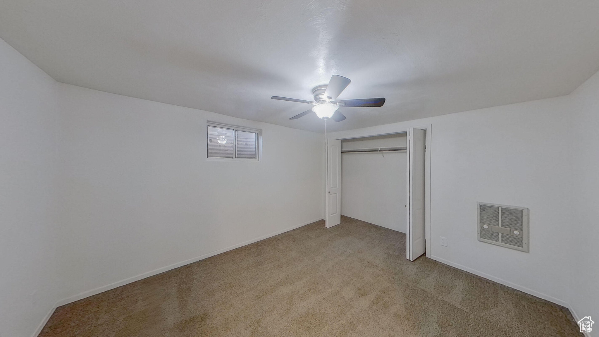 Unfurnished bedroom with light colored carpet, a closet, and ceiling fan