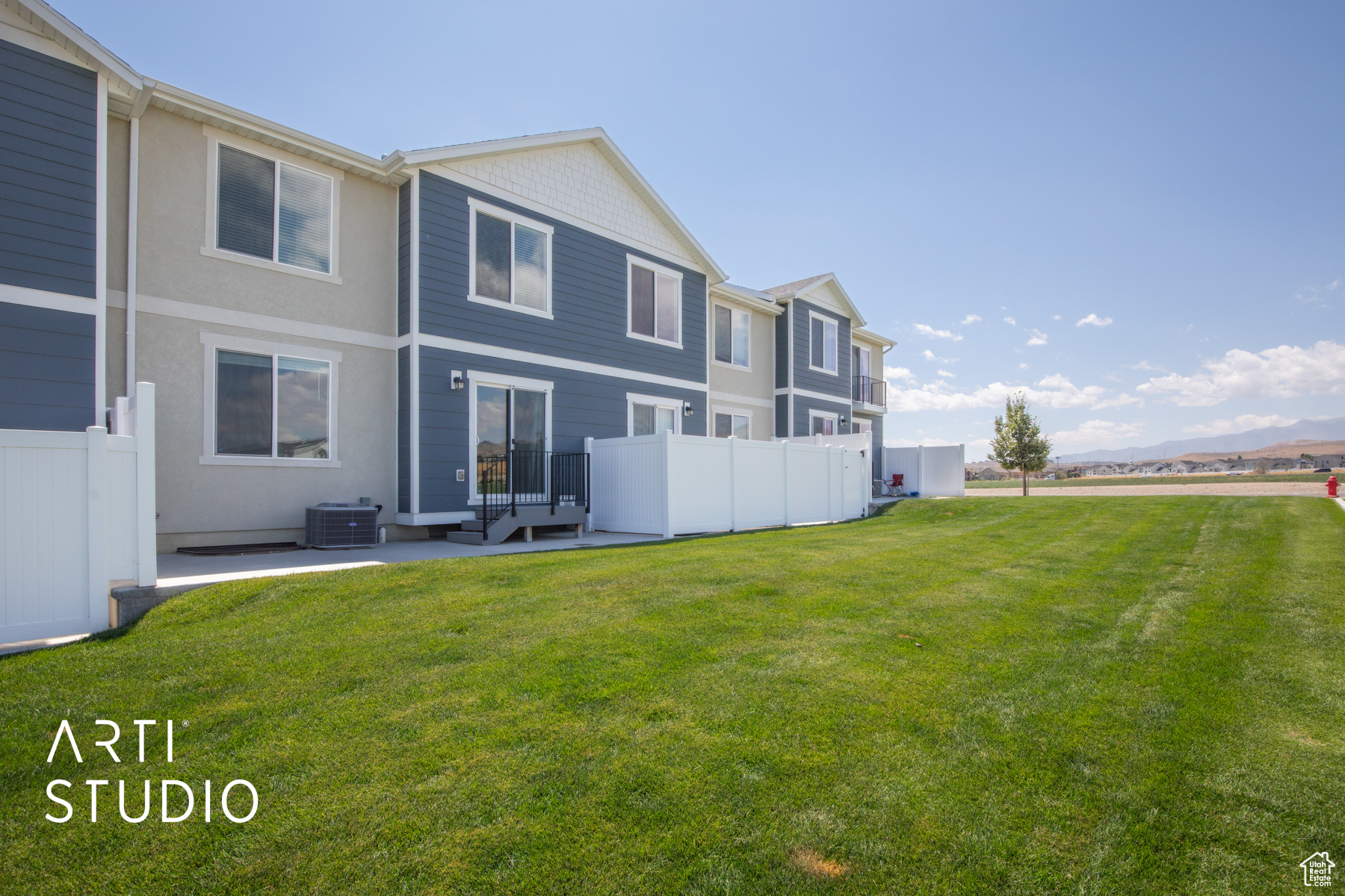 Rear view of house with a yard, an outdoor hangout area, a patio, and central AC unit