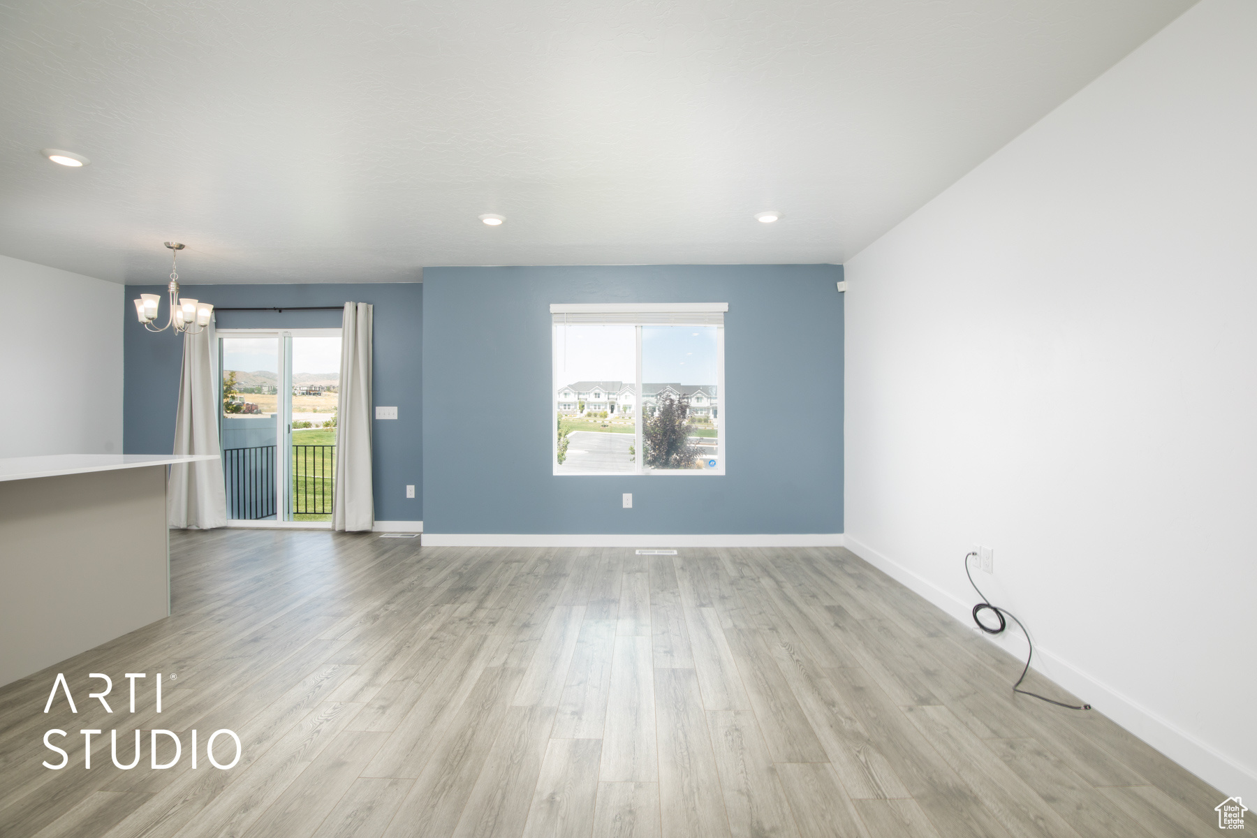 Unfurnished living room featuring light wood-type flooring and plenty of natural light