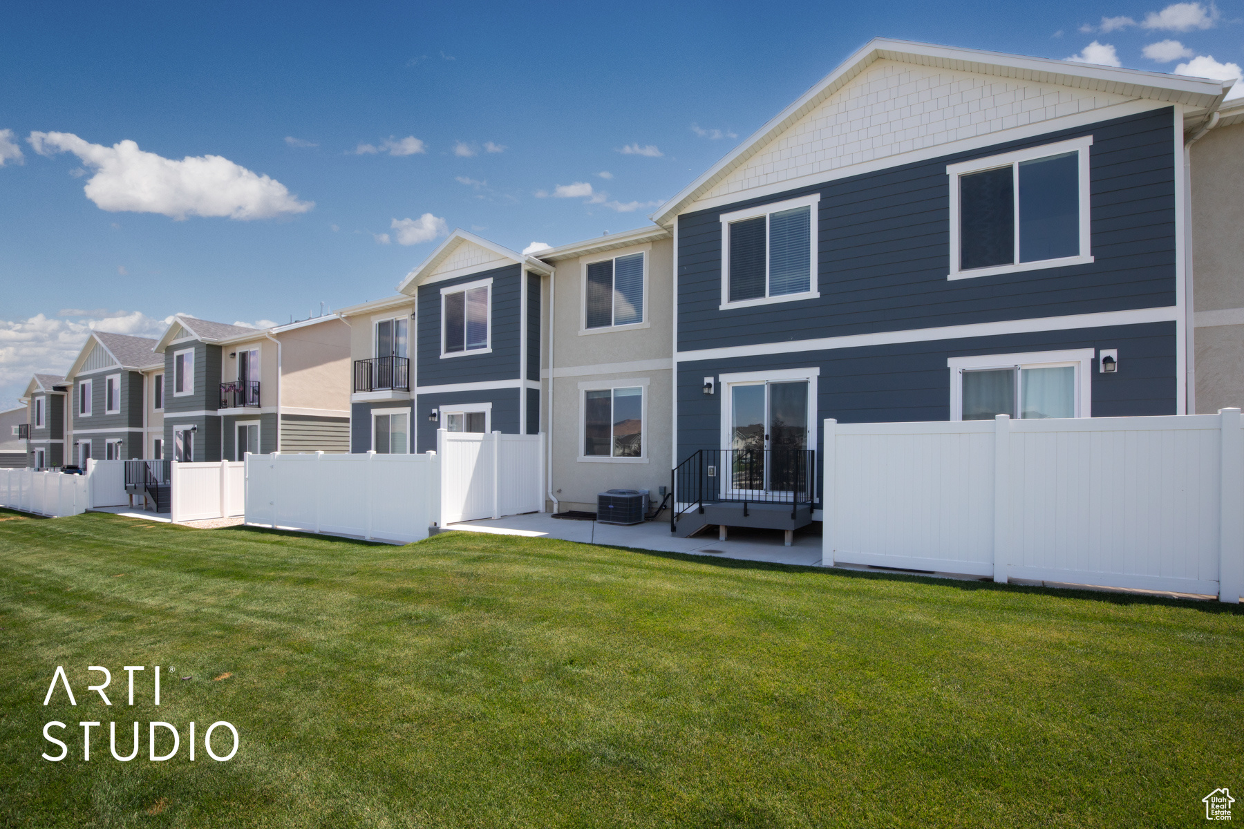 Back of property featuring a patio and a lawn