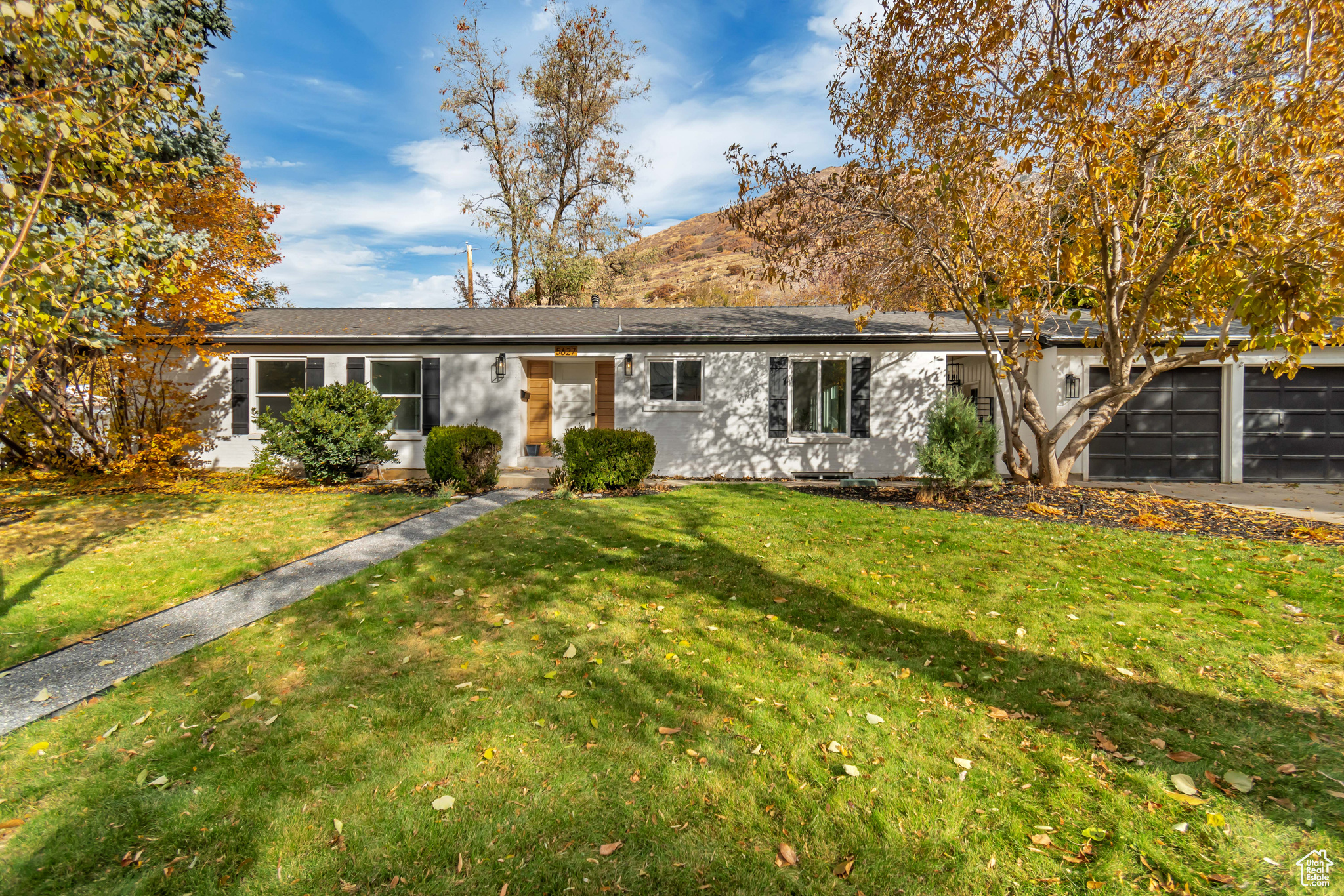 Single story home with a front lawn and a garage