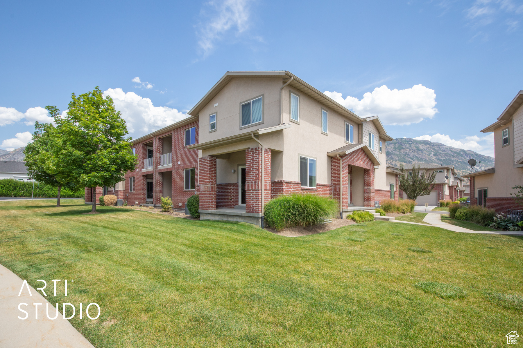 View of front of house featuring a front lawn and a mountain view