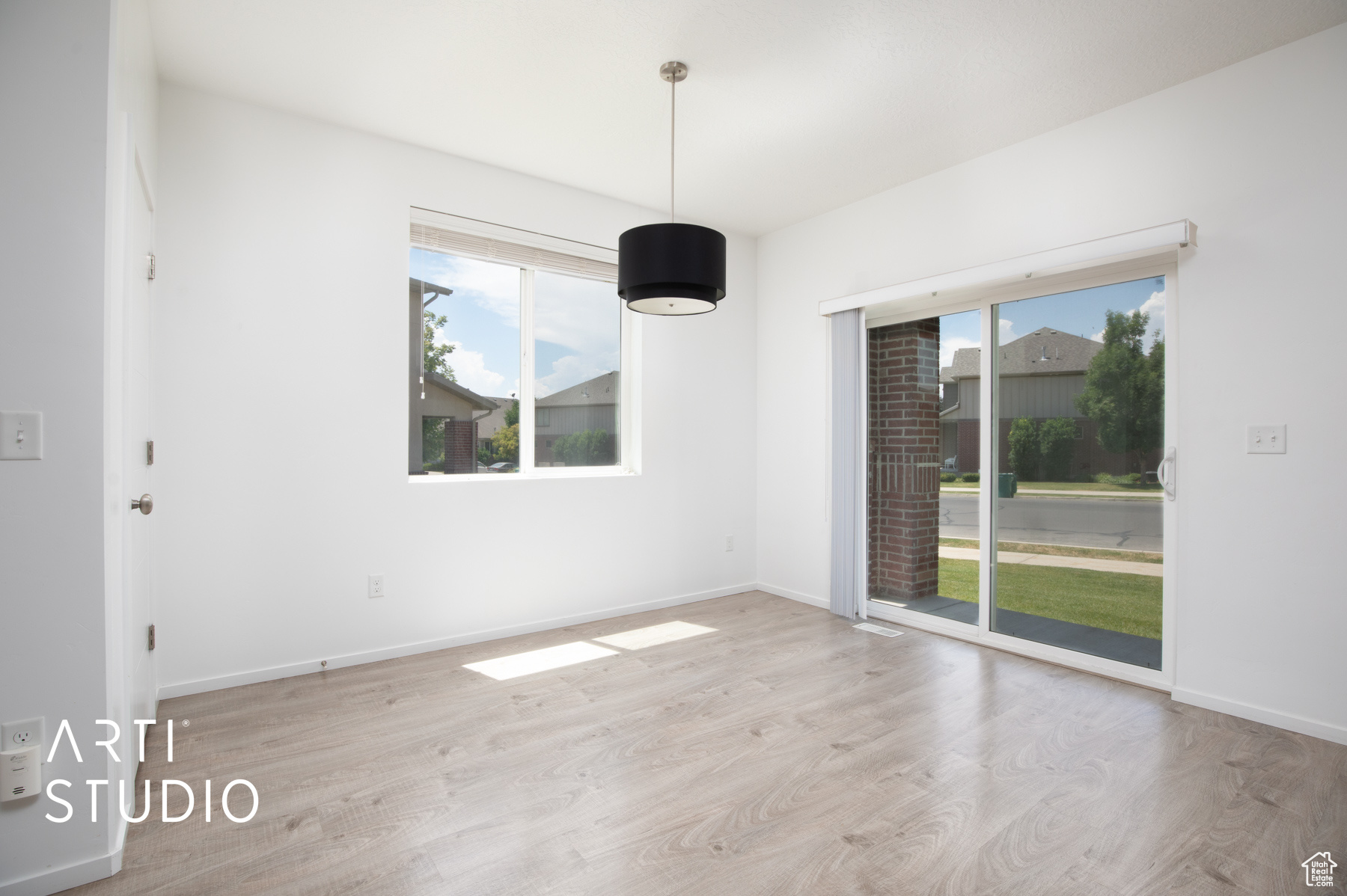 Unfurnished room featuring a healthy amount of sunlight and light hardwood / wood-style floors