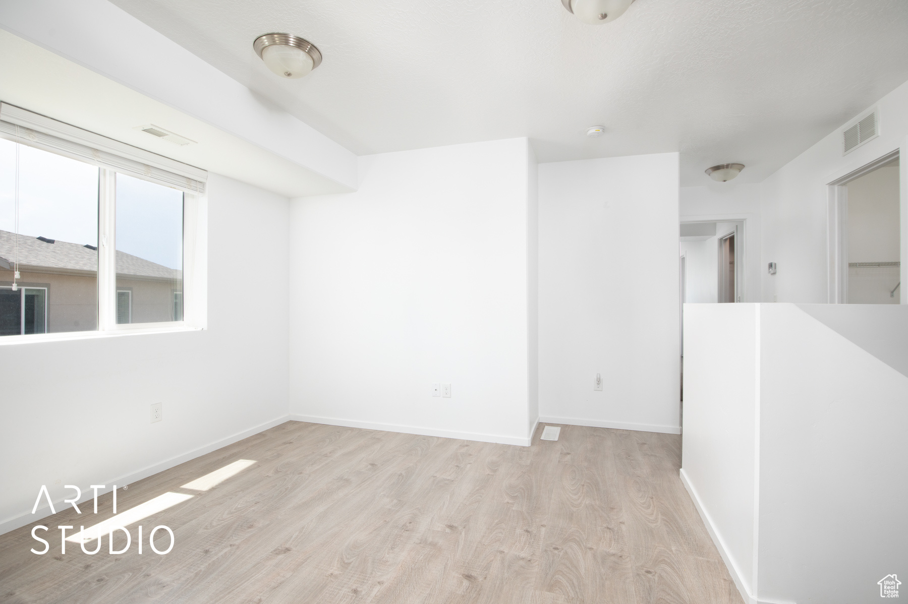 Unfurnished room featuring light wood-type flooring