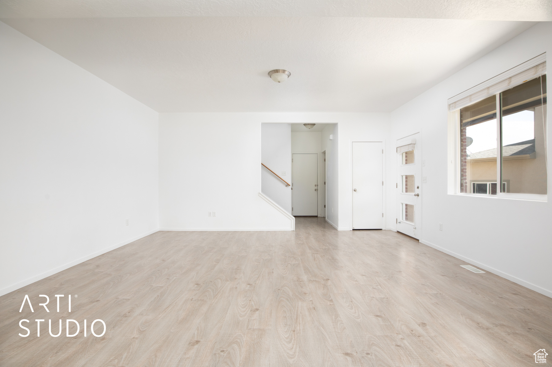 Empty room with light hardwood / wood-style flooring