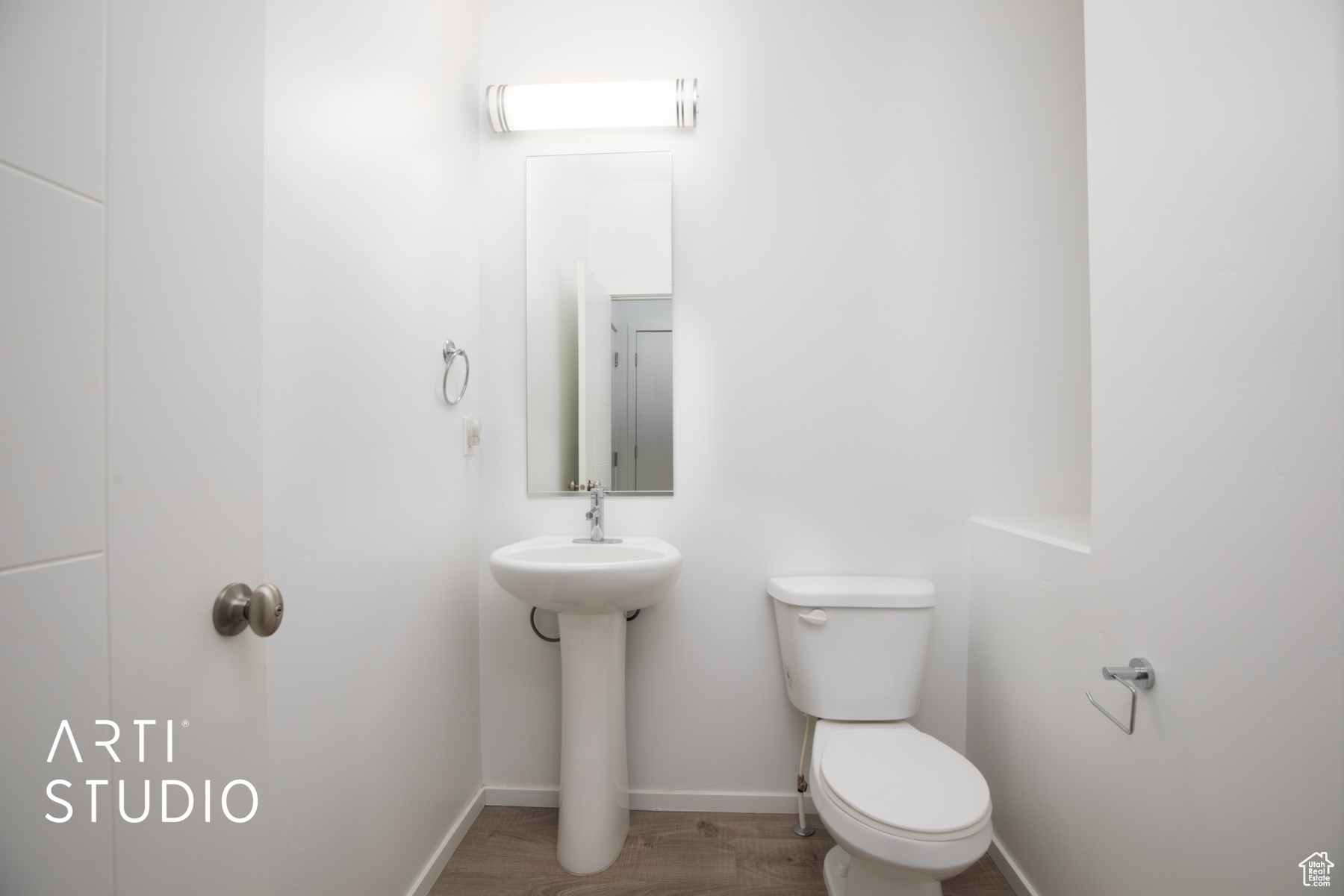 Bathroom featuring wood-type flooring and toilet