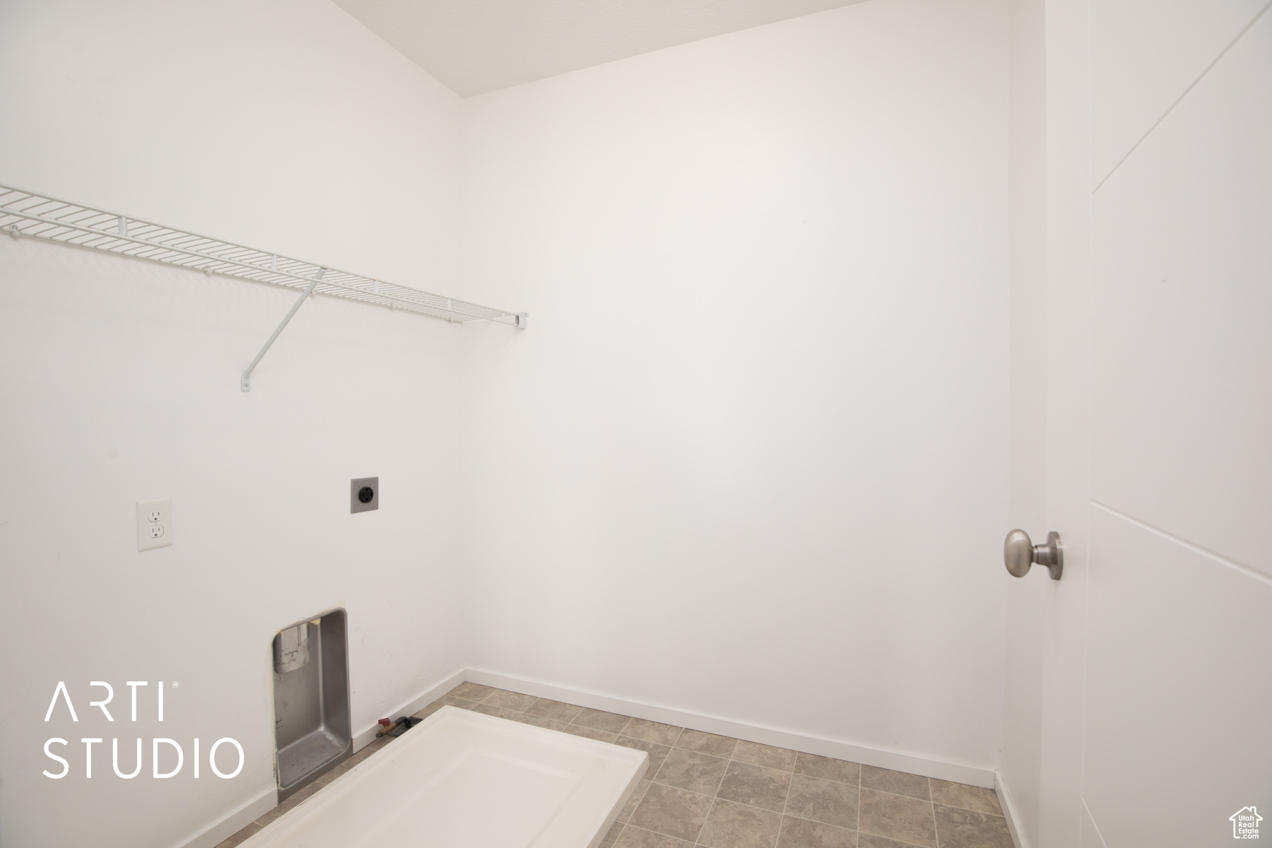 Clothes washing area with hookup for an electric dryer and tile patterned floors