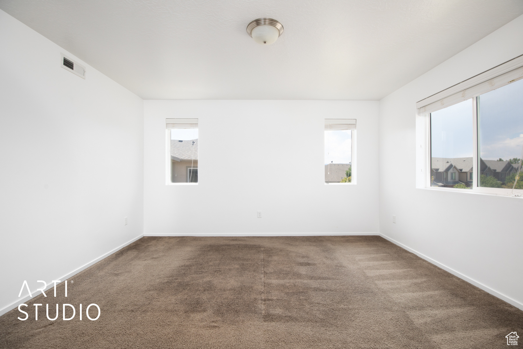 Carpeted empty room featuring plenty of natural light