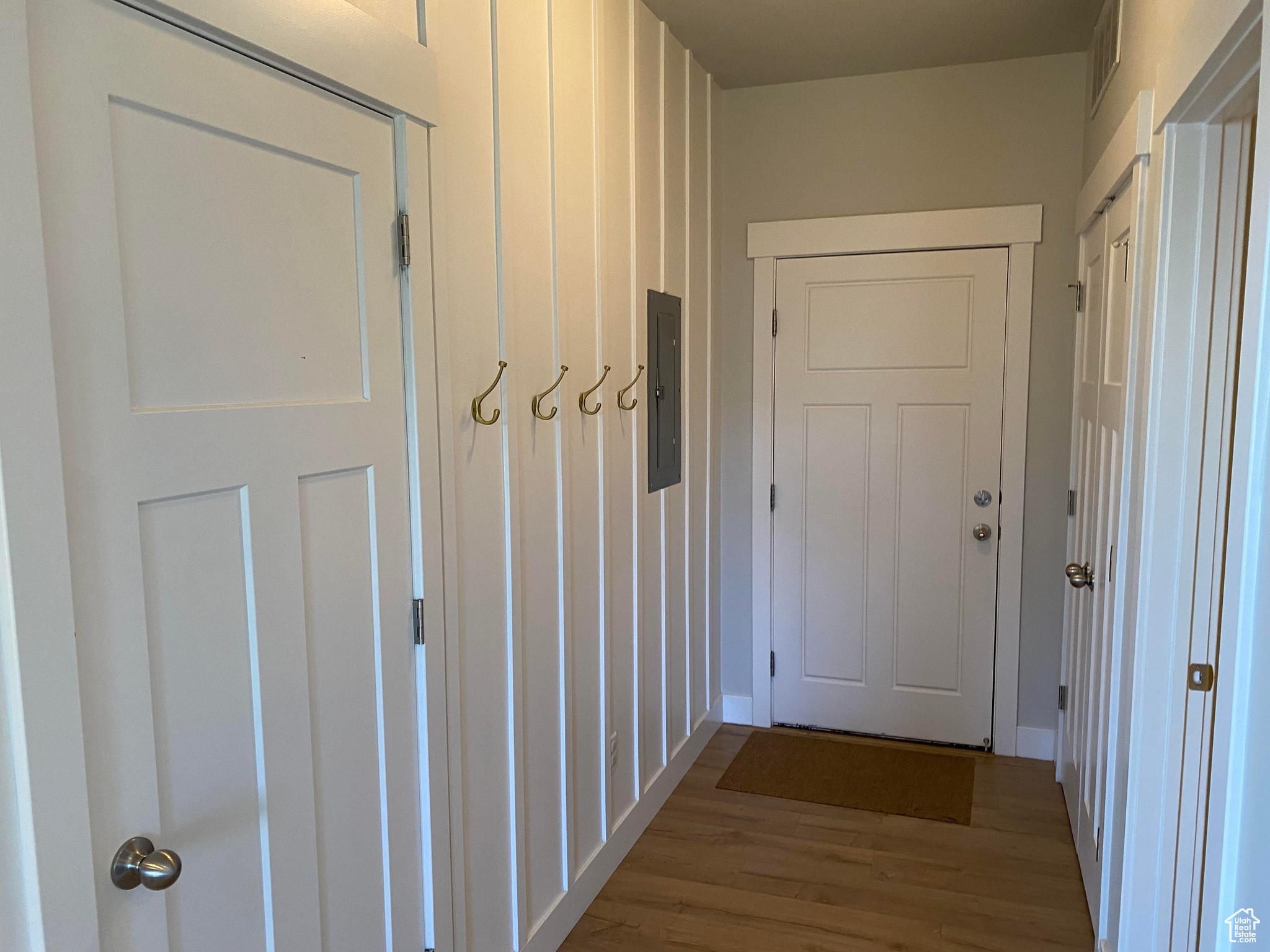 Hallway featuring light hardwood / wood-style floors and electric panel