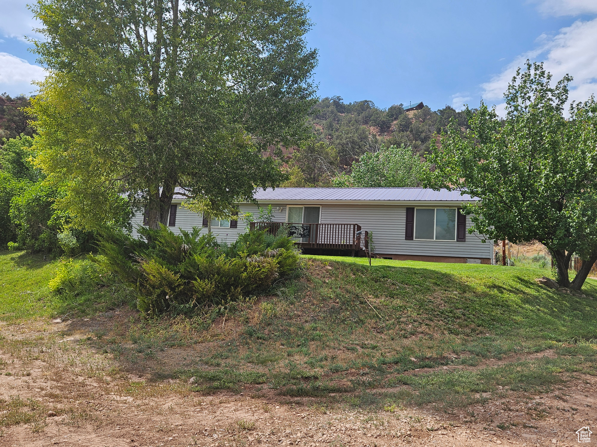 Exterior space featuring a yard and a deck