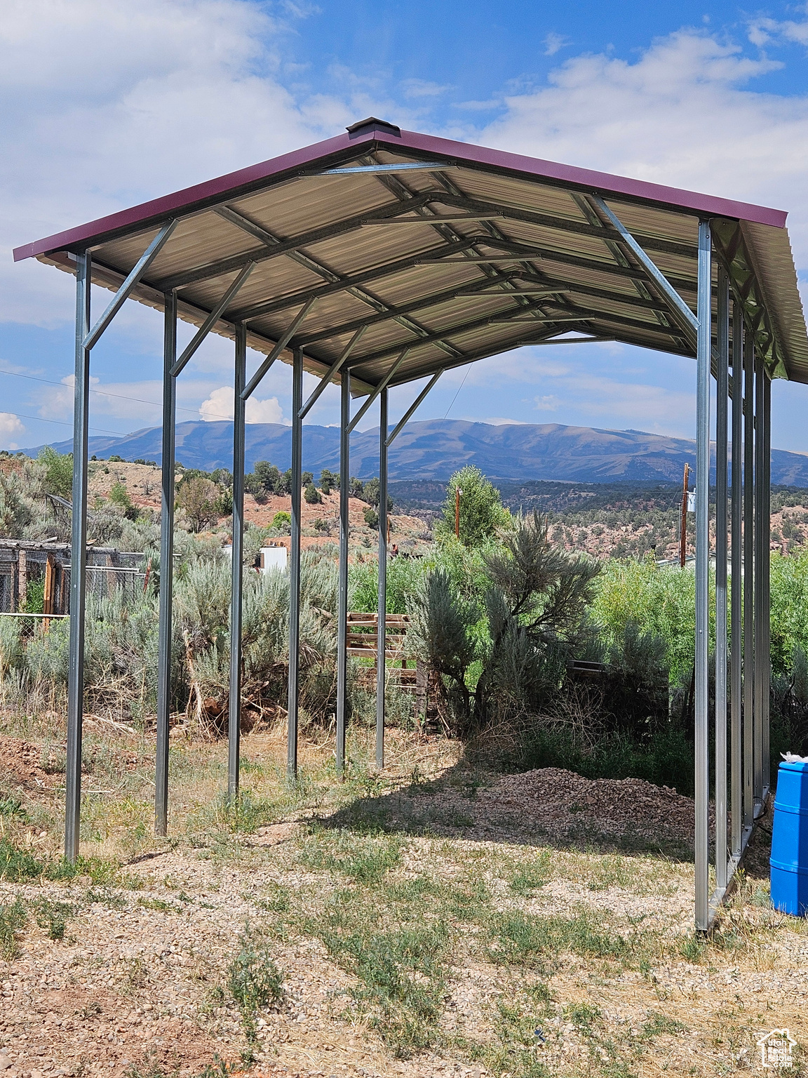 View of yard with a mountain view and a carport