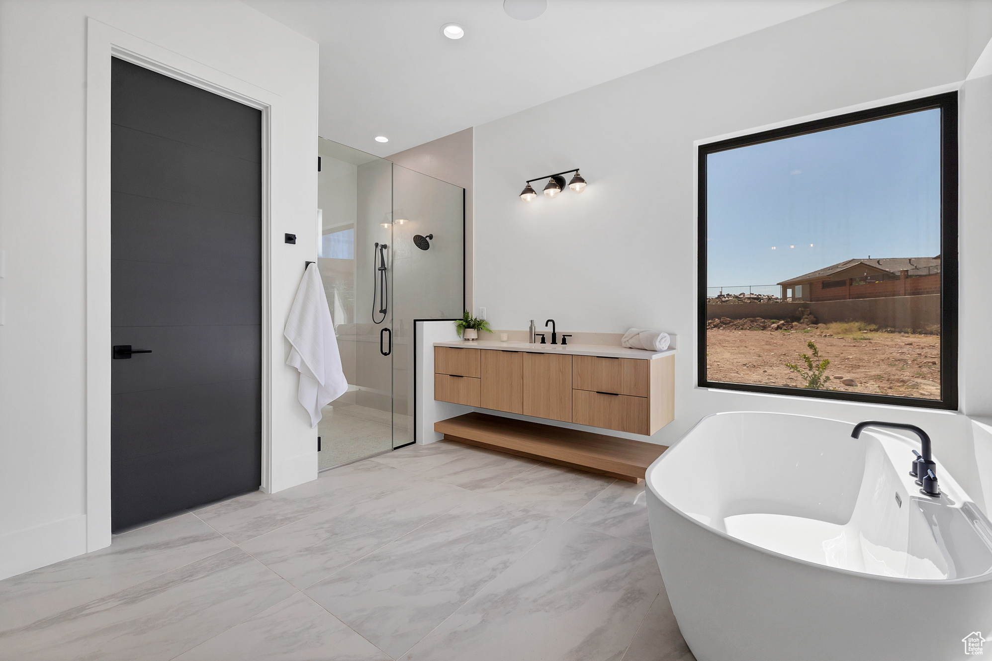 Bathroom featuring vanity, tile patterned floors, and separate shower and tub