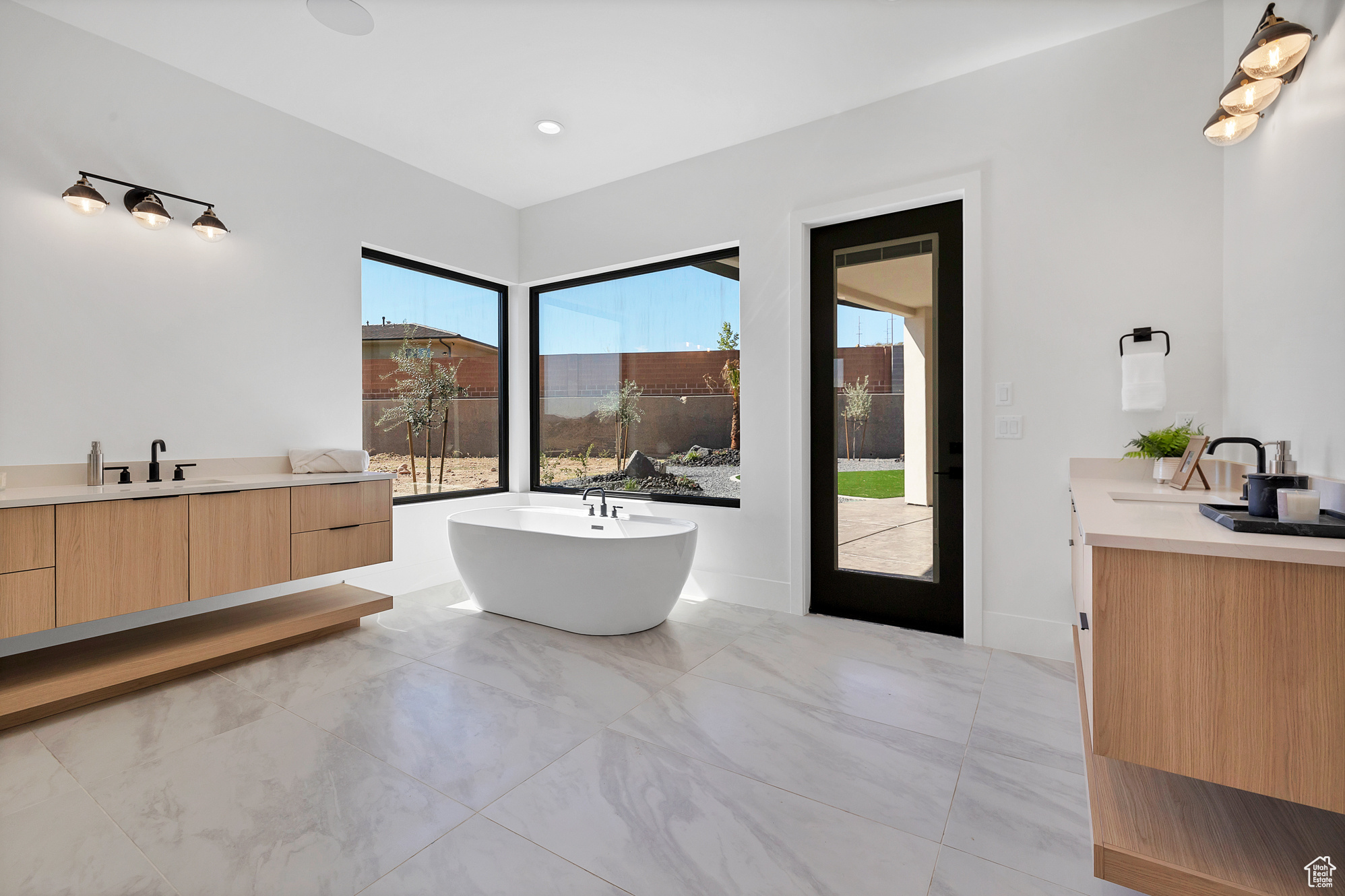 Bathroom with vanity, tile patterned floors, and plenty of natural light