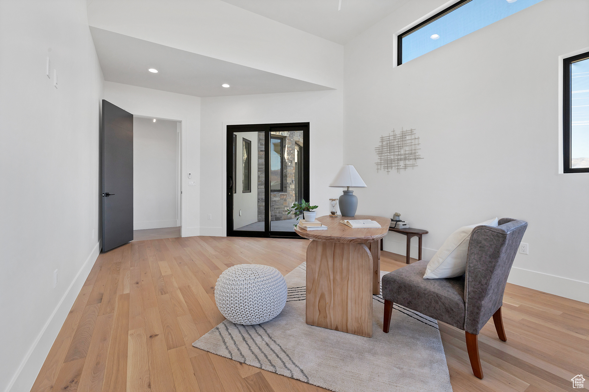 Living area with light hardwood / wood-style floors and a healthy amount of sunlight