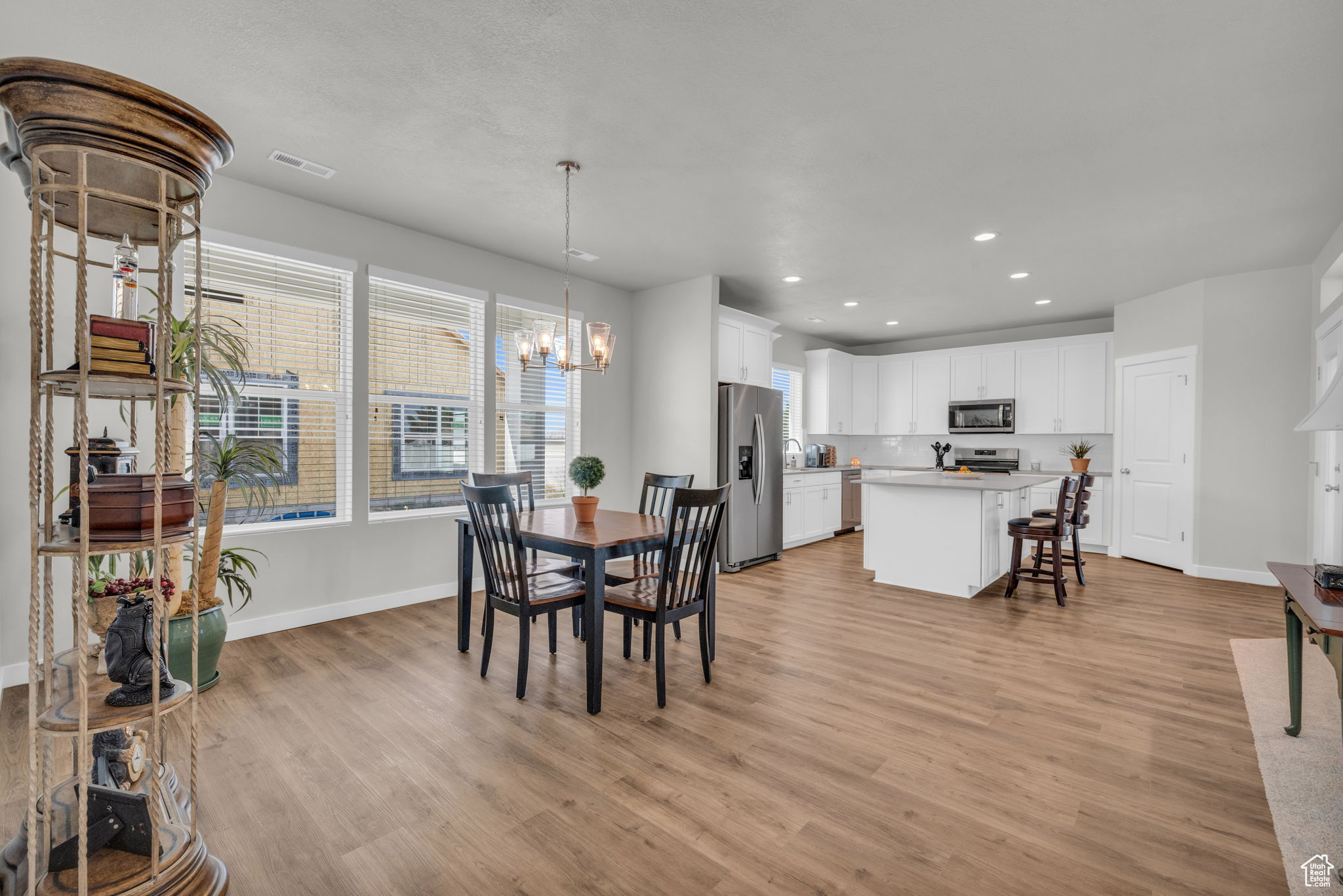 Dining room featuring light hardwood / wood-style floors and an inviting chandelier