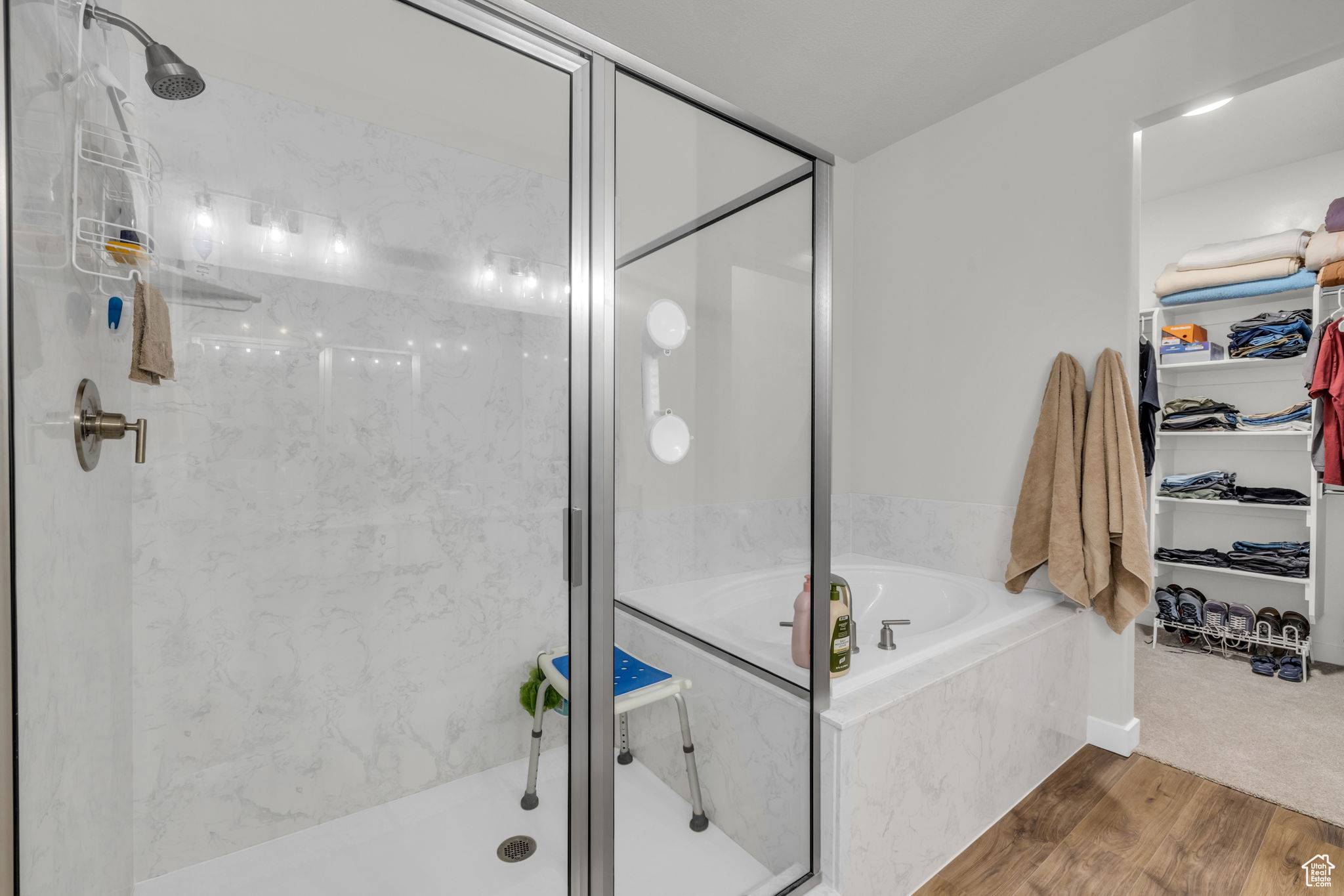 Bathroom featuring independent shower and bath and wood-type flooring