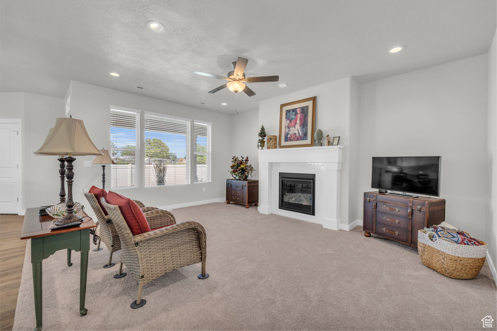 Living room with light wood-type flooring and ceiling fan