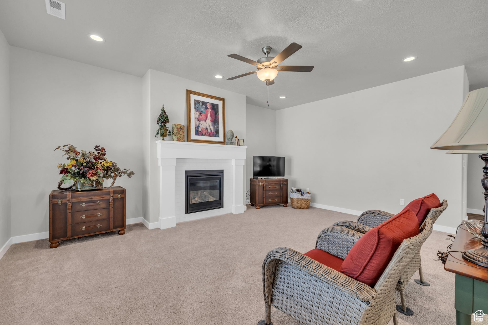 Living room with light colored carpet and ceiling fan