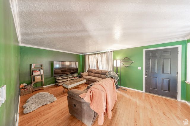 Living room with crown molding, light hardwood flooring