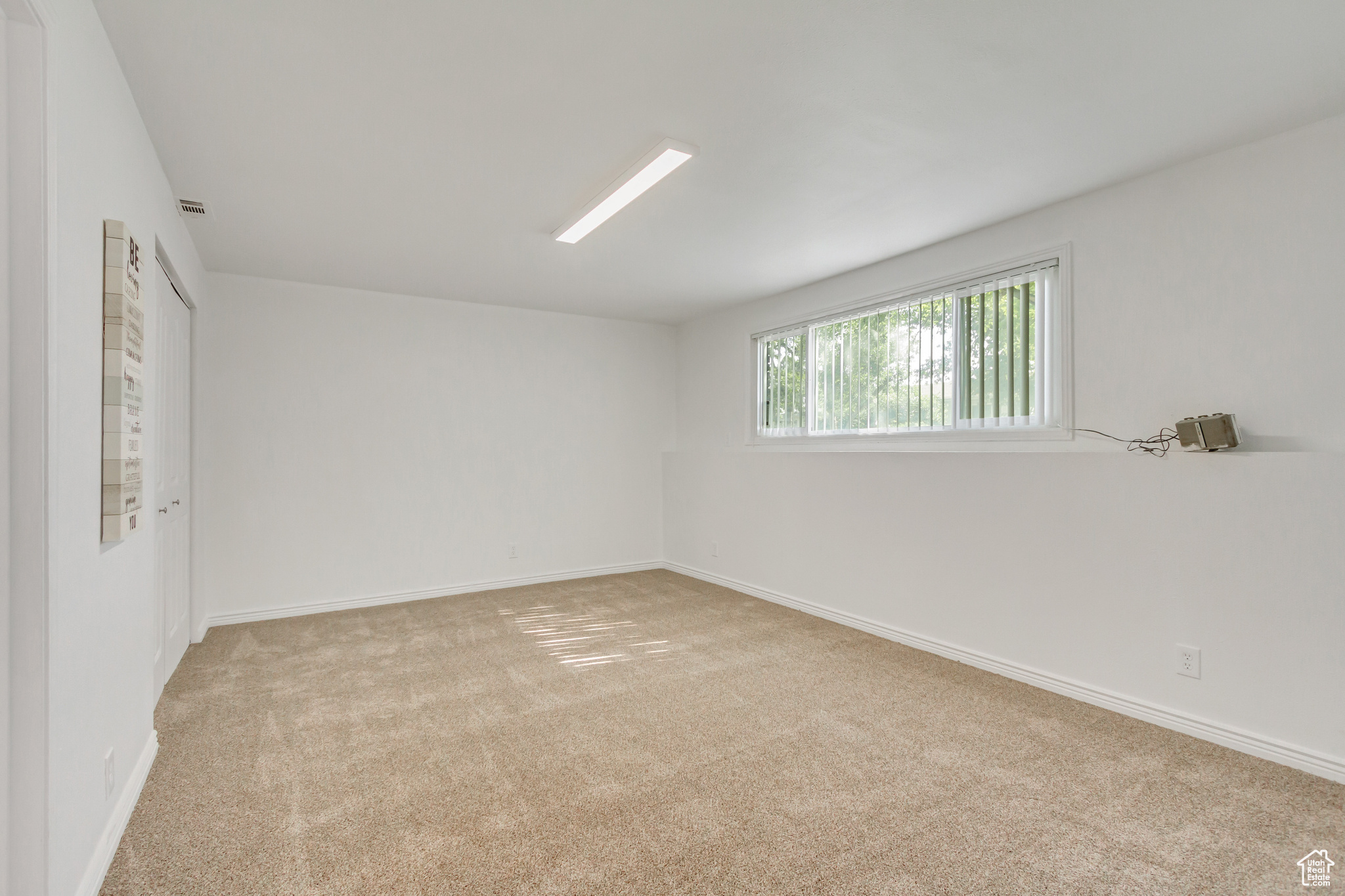 Bedroom or family room with light carpet