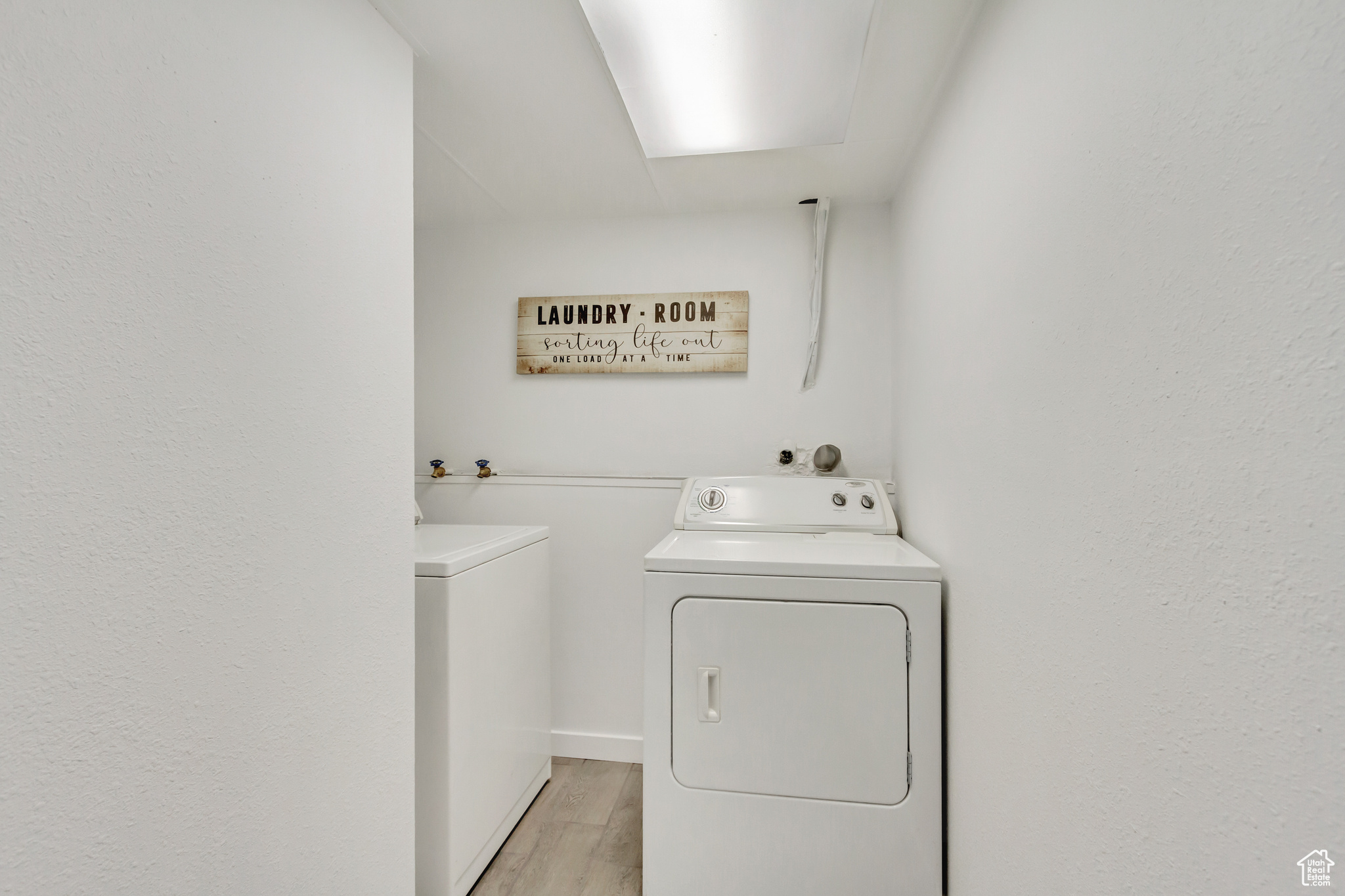 Laundry room with tile flooring and washing machine and clothes dryer