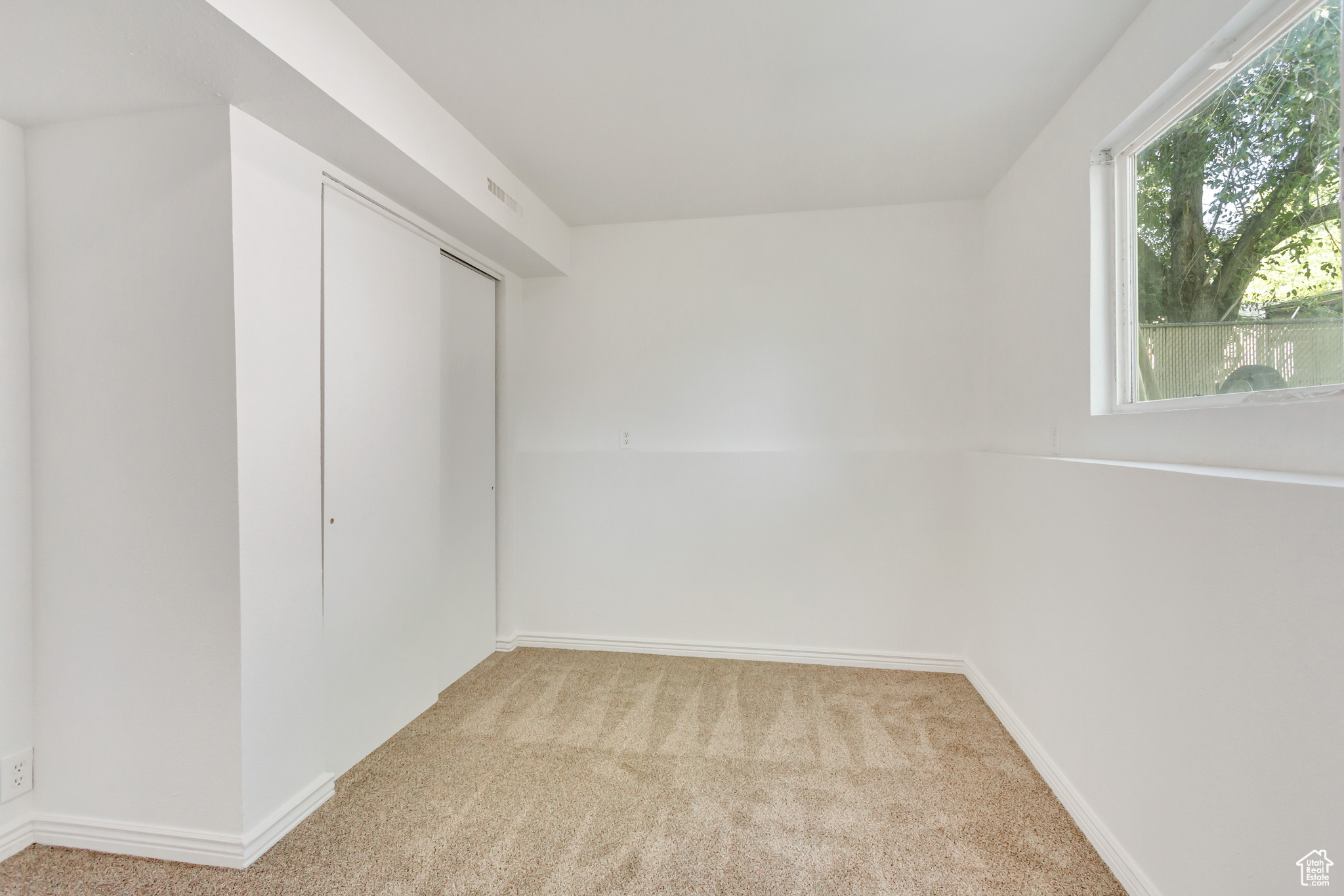 Bedroom featuring light colored carpet