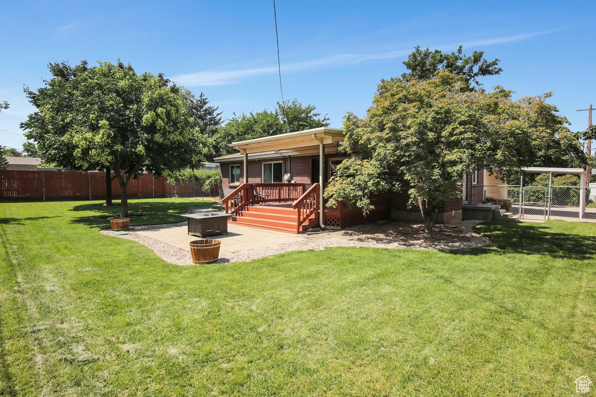 View of yard with a wooden deck