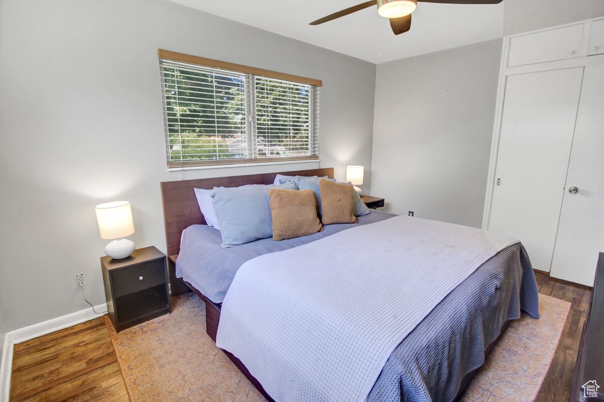 Bedroom featuring light hardwood / wood-style flooring, a closet, and ceiling fan