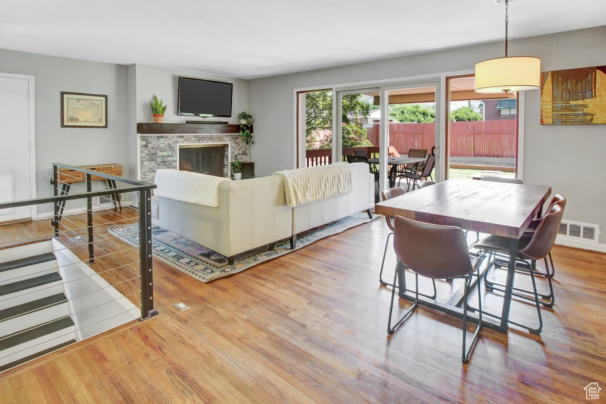 Living room featuring a brick fireplace and light wood-type flooring