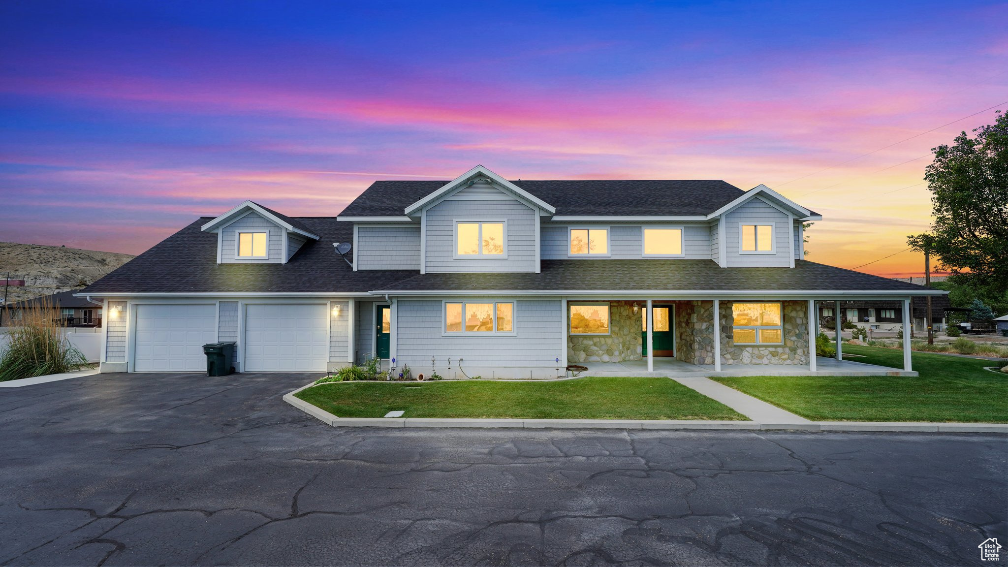 View of front of property featuring a garage and a lawn