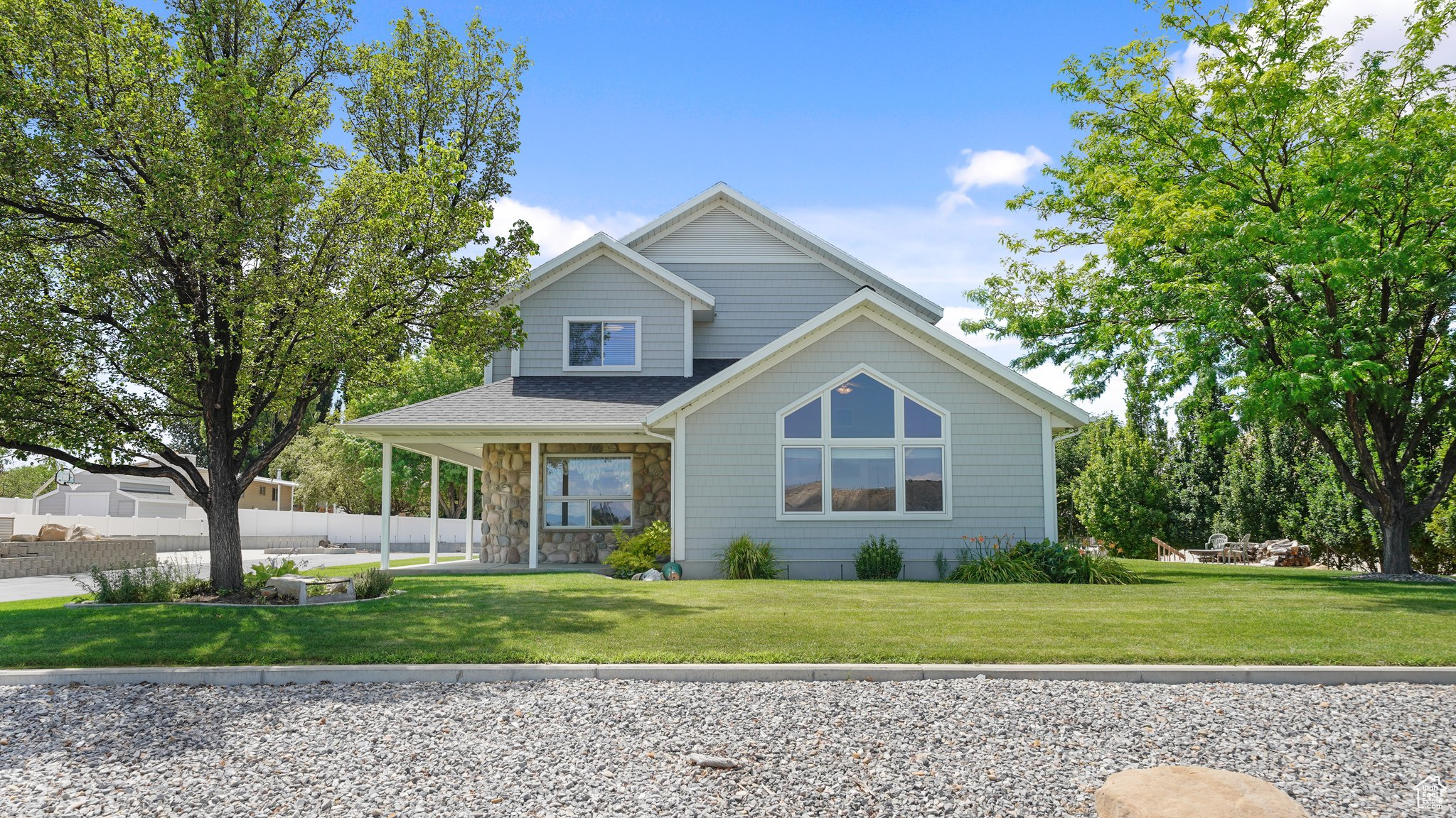 View of side of home with a front lawn