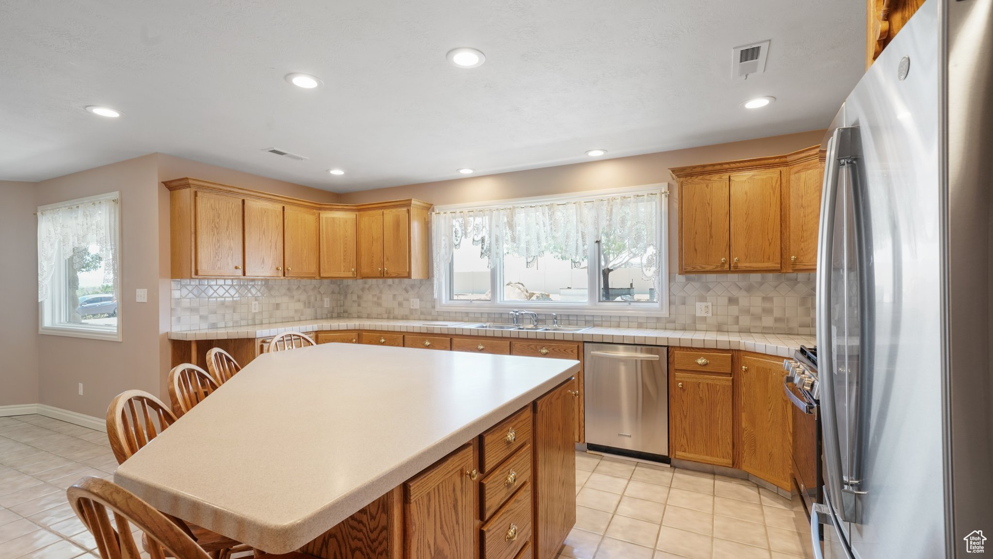 Kitchen featuring plenty of natural light, stainless steel appliances, and light tile patterned floors