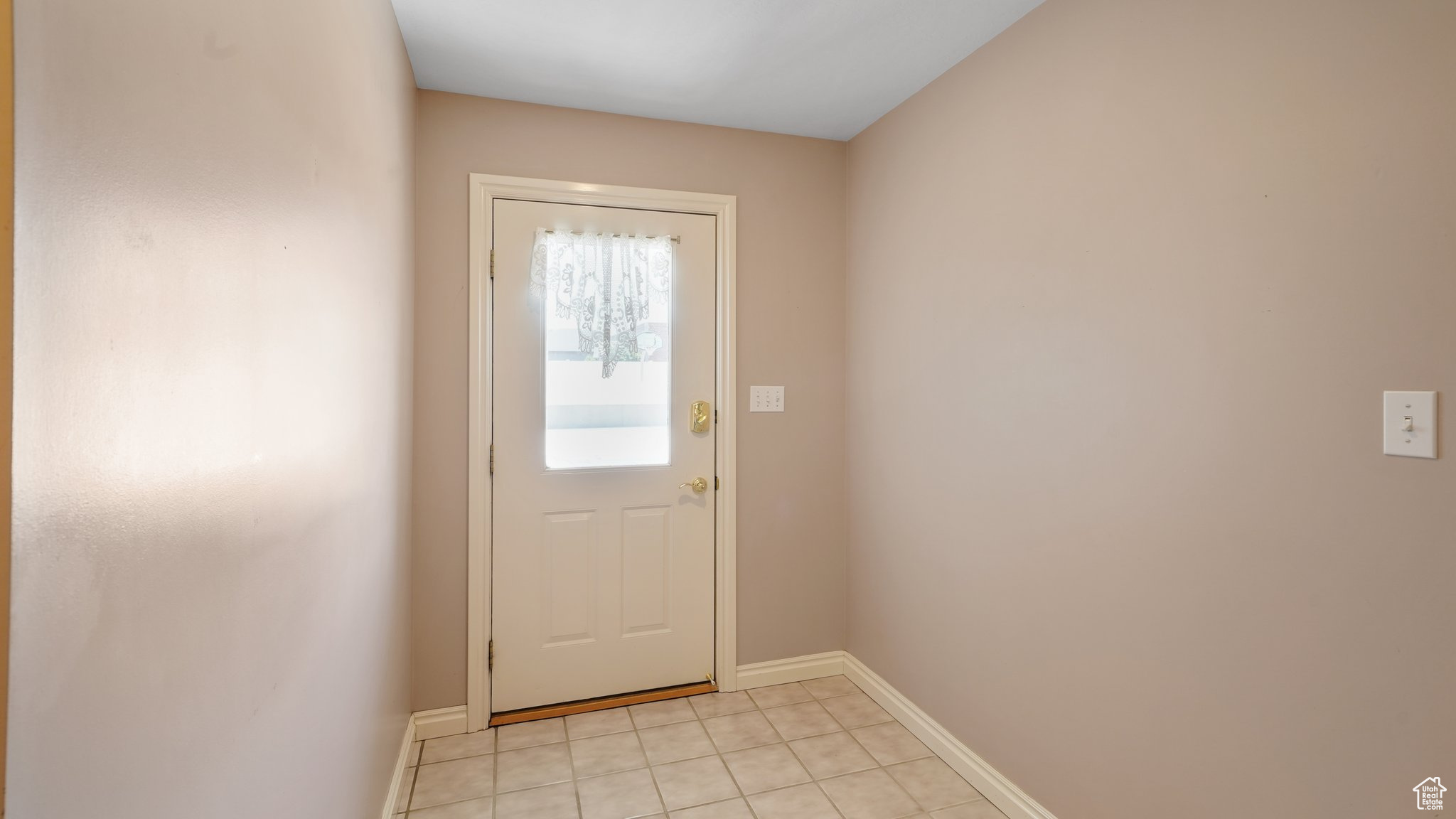 Doorway to outside with light tile patterned floors