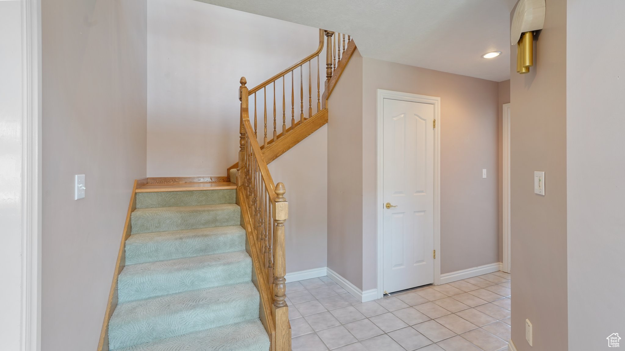 Stairway featuring light tile patterned floors