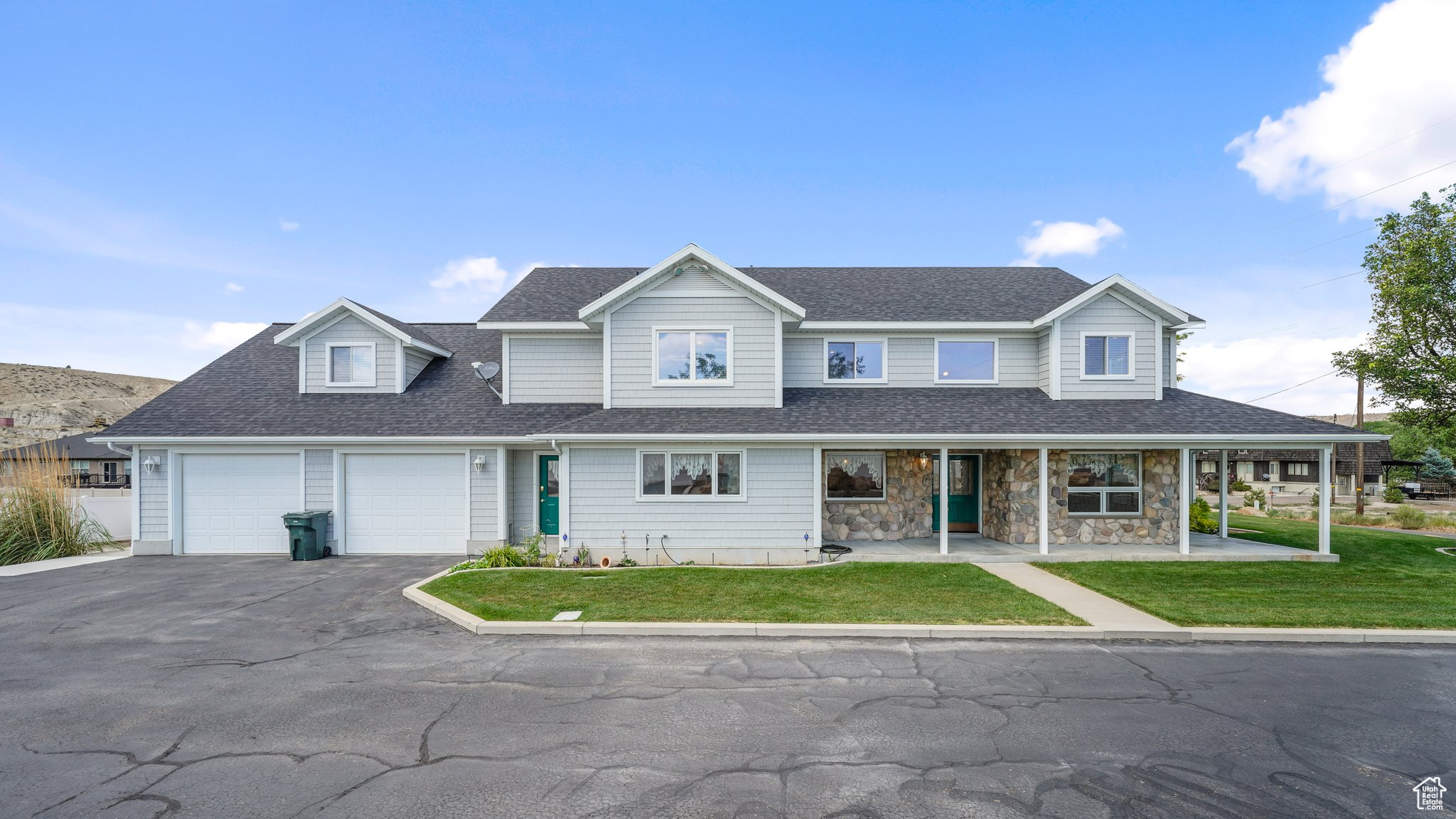 View of front of home with a garage and a front lawn