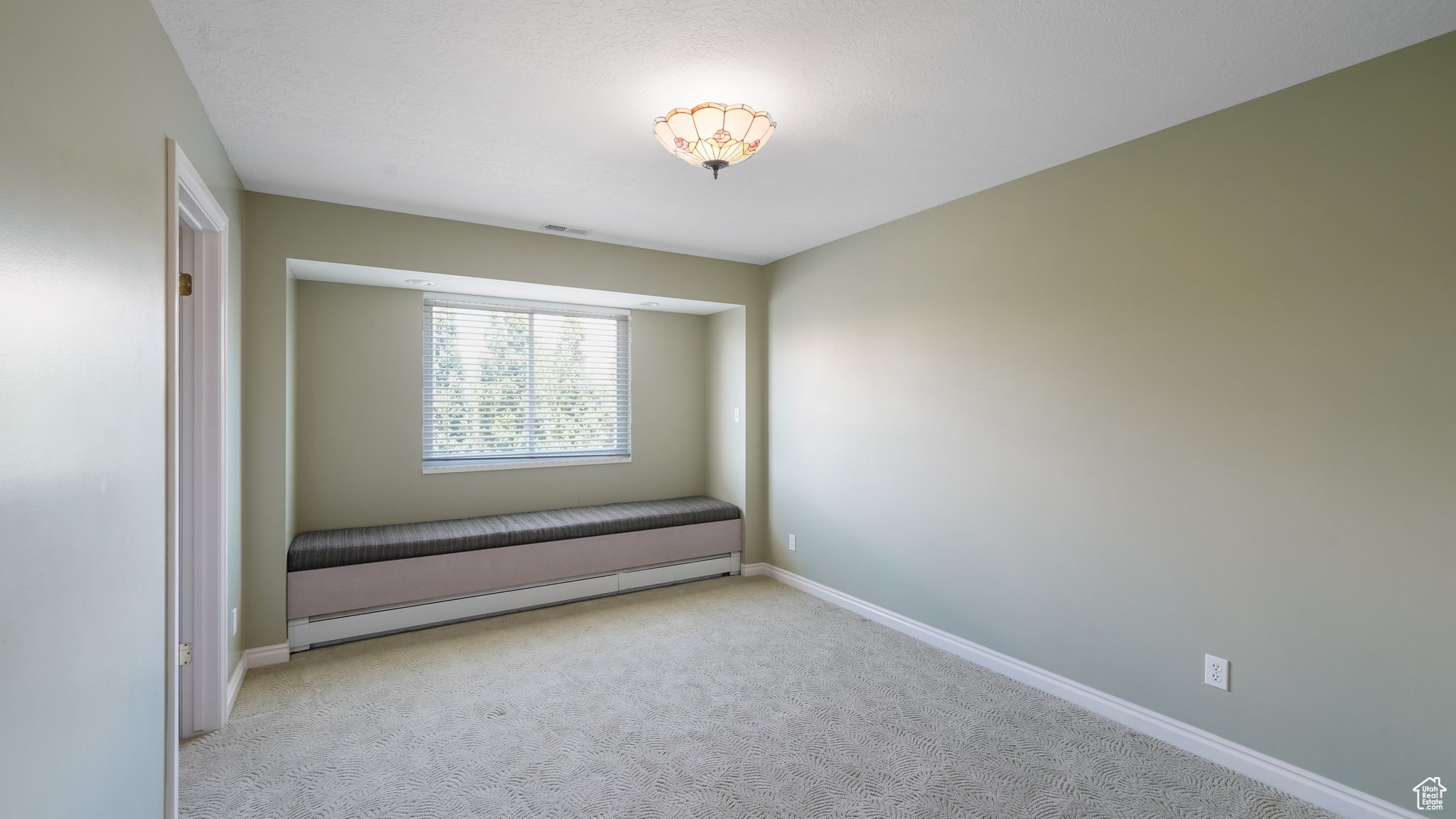 Spare room featuring light carpet