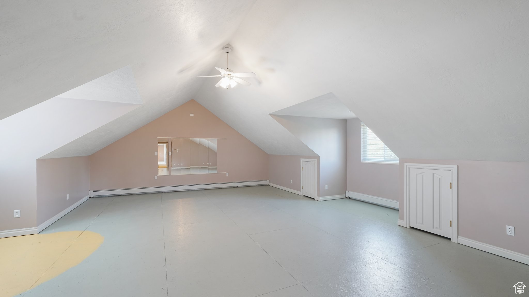 Bonus room with light tile patterned flooring, vaulted ceiling, a baseboard radiator, and ceiling fan