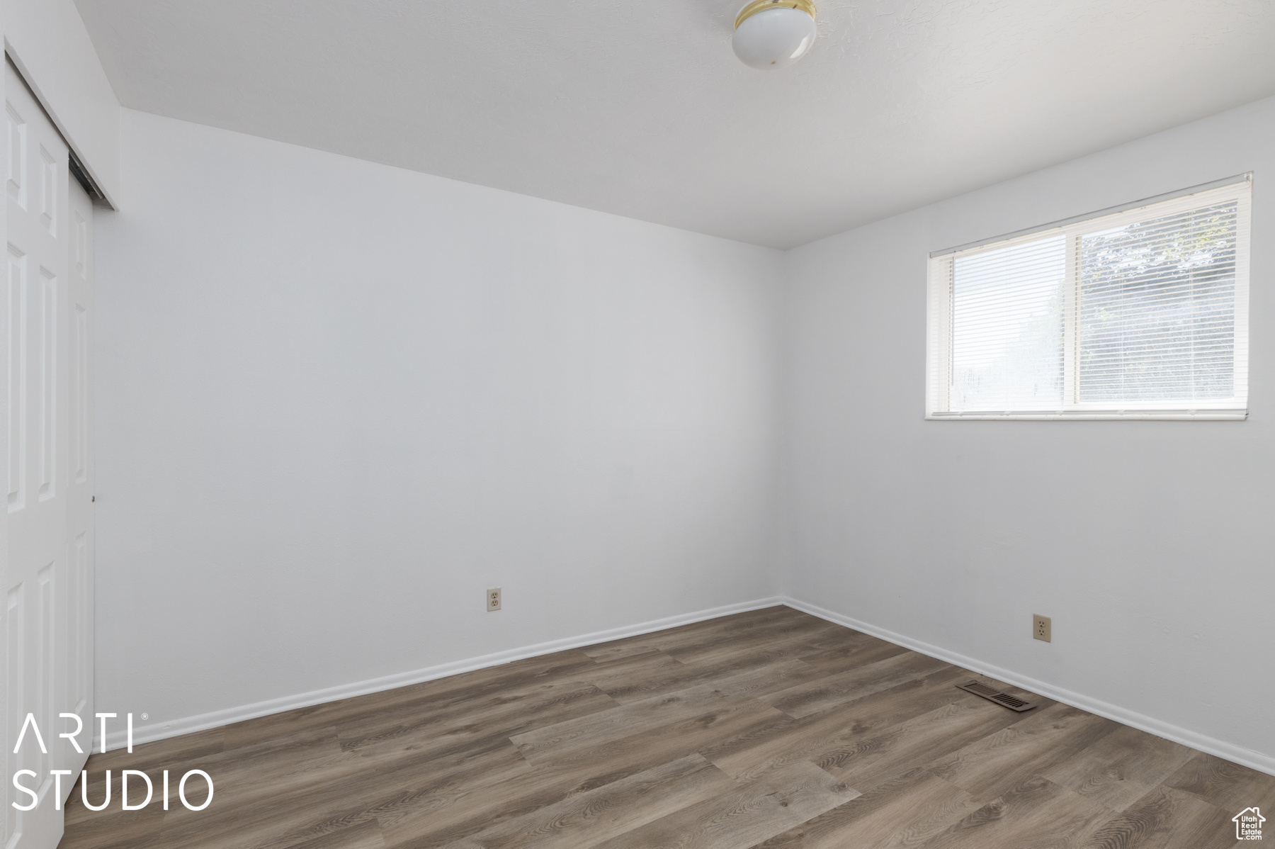 Spare room featuring wood-type flooring