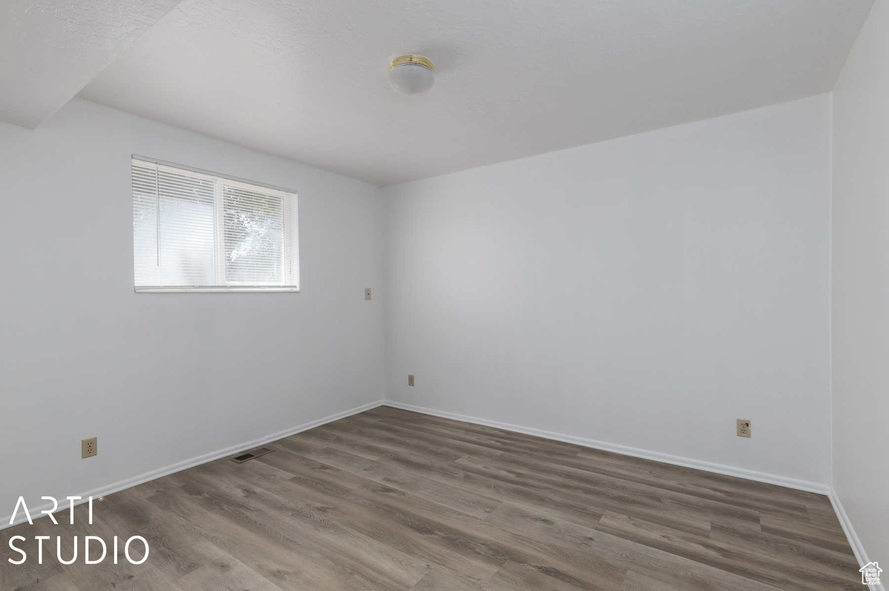 Spare room featuring wood-type flooring